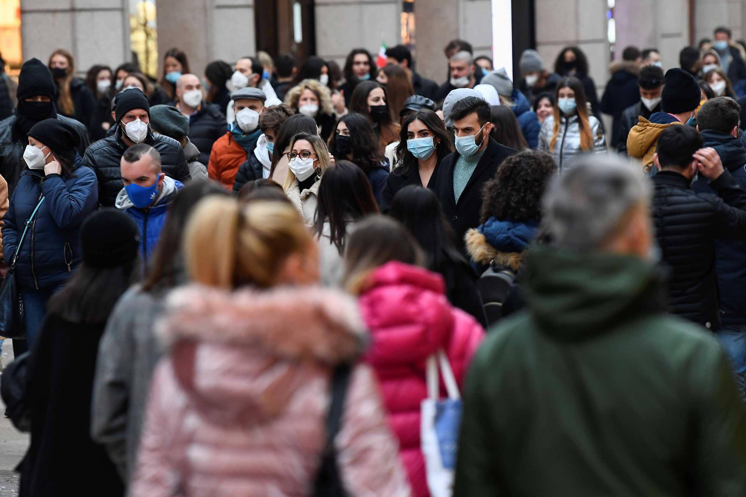 People walk around the city centre as the coronavirus disease (COVID-19) restrictions are relaxed allowing people to sit outside and enjoy a drink until 6pm, in Milan, Italy, February 6, 2021. REUTERS