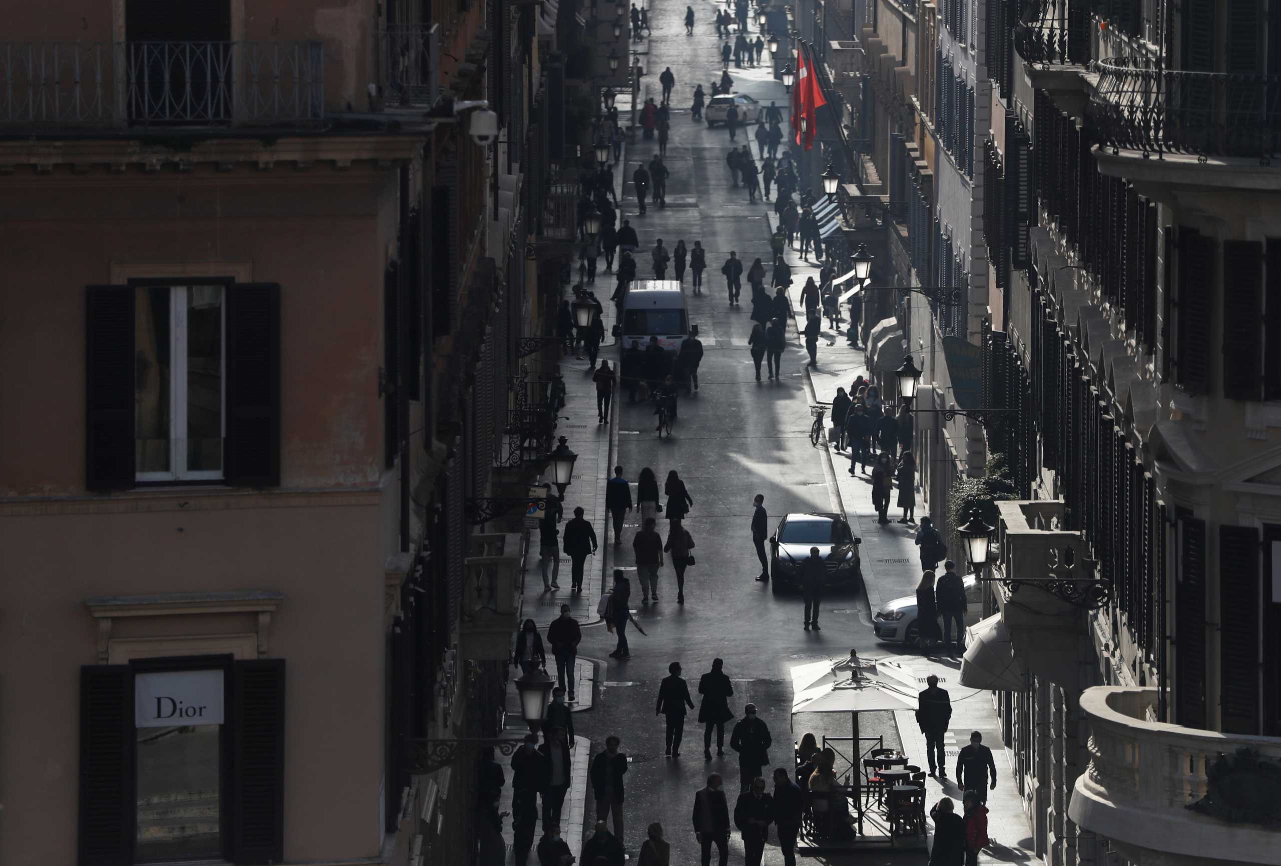 People walk along Via dei Condotti amid the coronavirus disease (COVID-19) outbreak in Rome, Italy, February 26, 2021. REUTERS