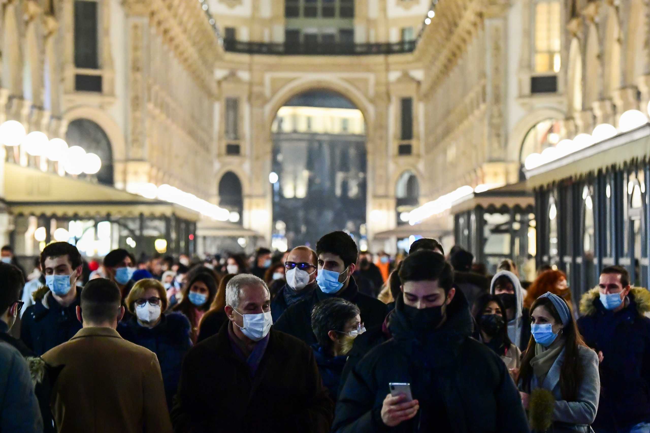 People walk around the city centre as the coronavirus disease (COVID-19) restrictions are relaxed allowing people to sit outside and enjoy a drink until 6pm, in Milan, Italy, February 6, 2021. REUTERS