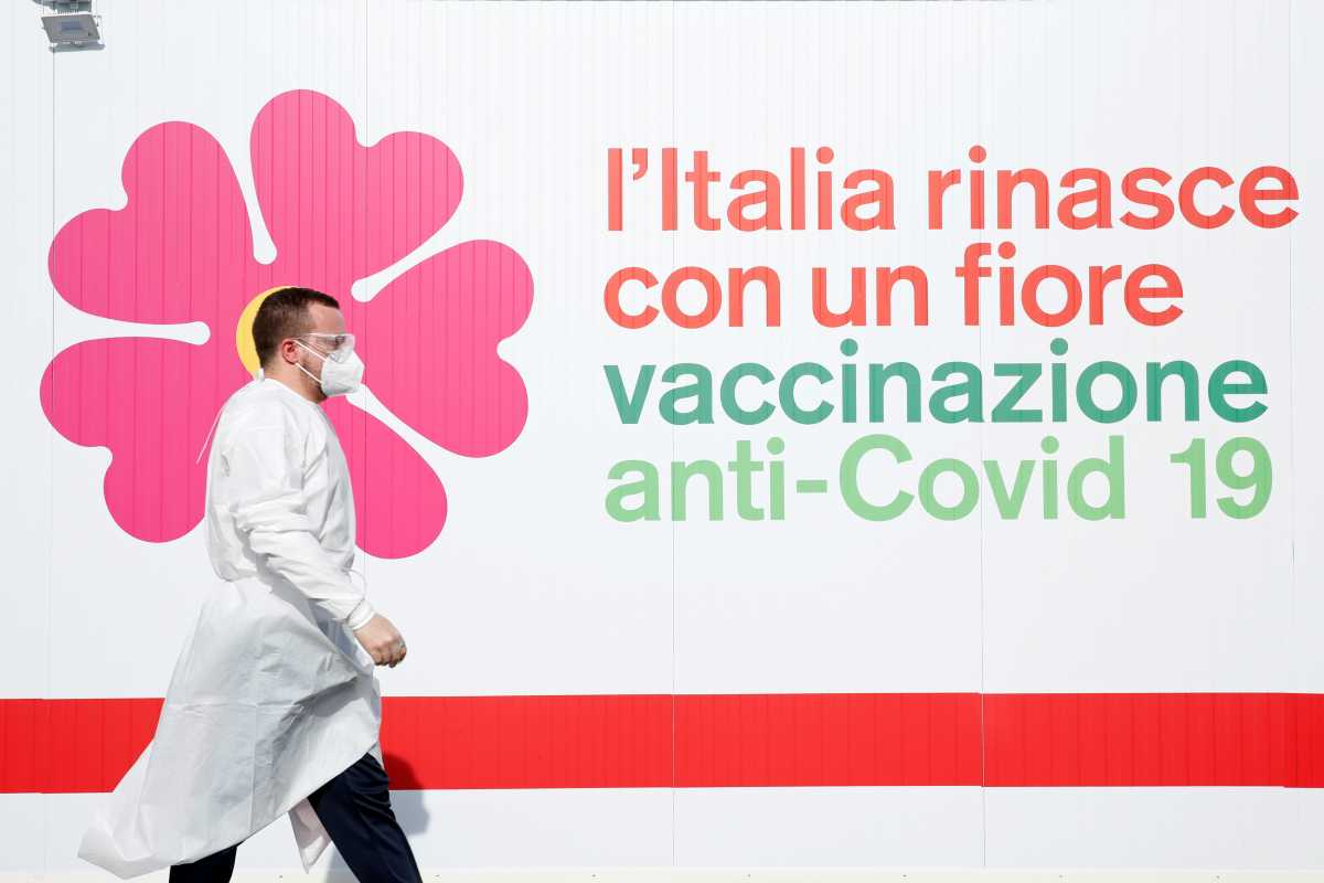 A man walks outside a tent during preparations to turn the long-term car park at Fiumicino airport into a coronavirus disease (COVID-19) vaccination centre, in Rome, Italy, February 5, 2021. REUTERS