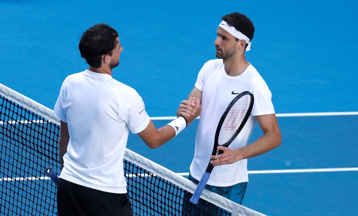Tennis - Australian Open - Melbourne Park, Melbourne, Australia, February 14, 2021 Bulgaria's Grigor Dimitrov and Austria's Dominic Thiem after their fourth round match REUTERS