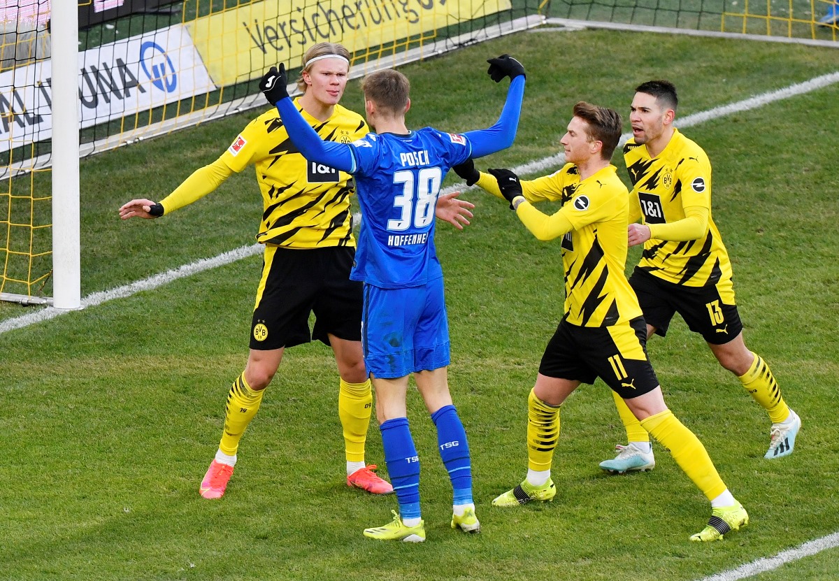 Soccer Football - Bundesliga - Borussia Dortmund v TSG 1899 Hoffenheim - Signal Iduna Park, Dortmund, Germany - February 13, 2021 TSG 1899 Hoffenheim's Stefan Posch clashes with Borussia Dortmund's Erling Braut Haaland after he scores their second goal Pool via REUTERS