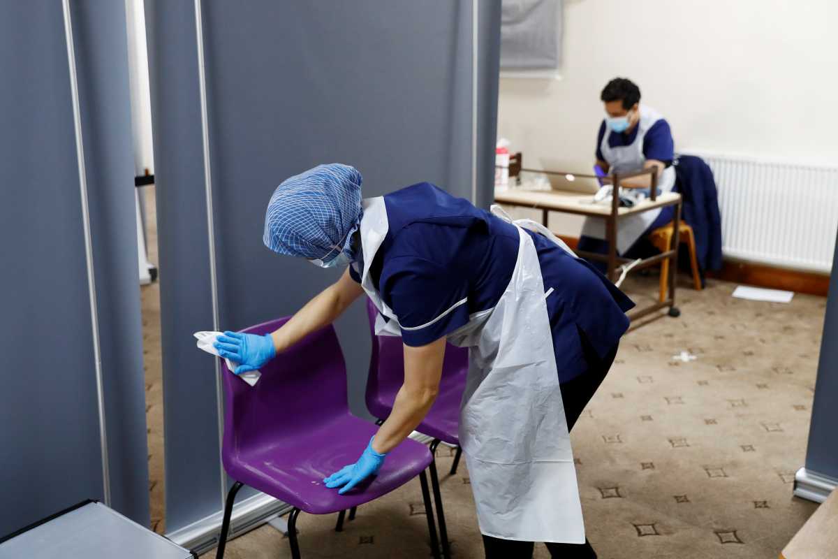 Nurse Zenub Mahood sanitises a seat at Bradford Central Mosque, amid the coronavirus disease (COVID-19) outbreak in Bradford, Britain, February 25, 2021. REUTERS