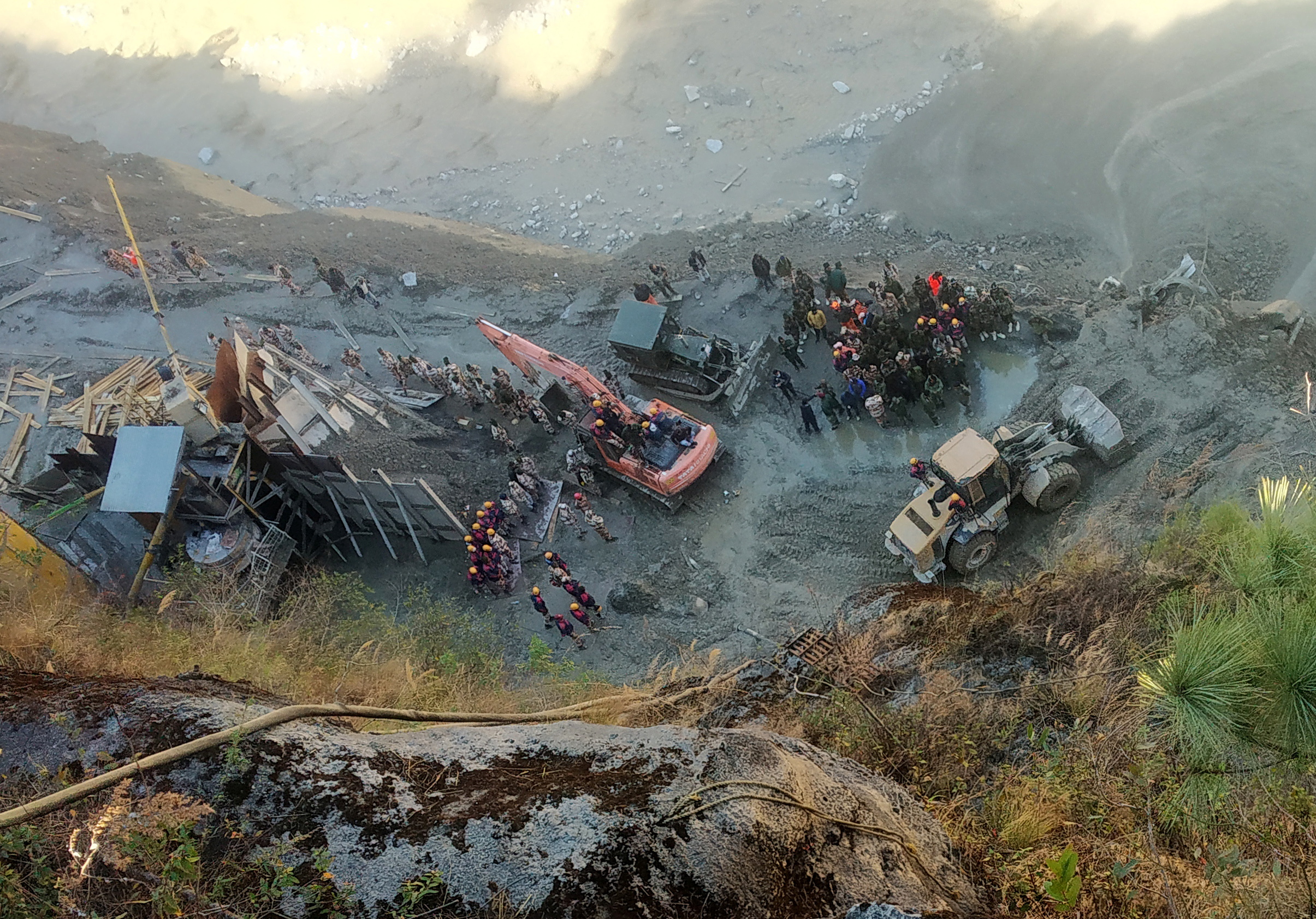 Rescue team members work near a tunnel after a part of a glacier broke away and caused flood in Tapovan, northern state of Uttarakhand, India, February 8, 2021. REUTERS