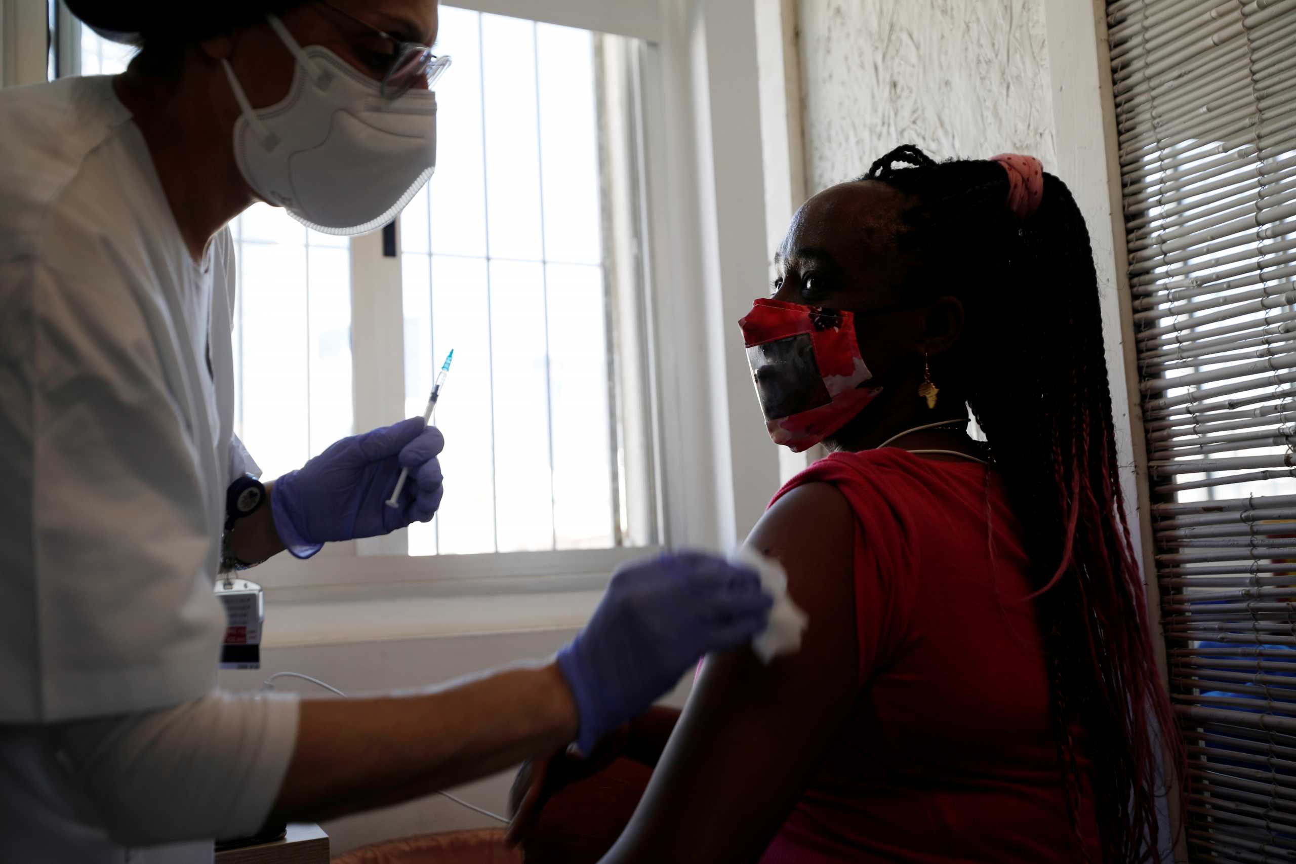 A medical worker administers a vaccination against the coronavirus disease (COVID-19) at a newly-opened centre in a neighbourhood with a high residency of foreign nationals, including migrant workers, in Tel Aviv, Israel February 9, 2021. REUTERS