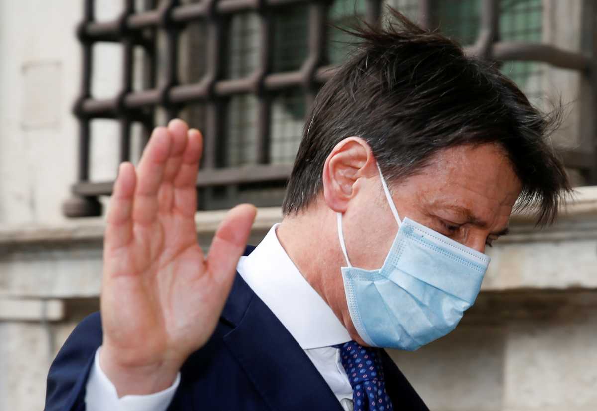 Italy's caretaker Prime Minister Giuseppe Conte waves as he leaves after speaking to the media outside Chigi Palace, in Rome, Italy, February 4, 2021. REUTERS