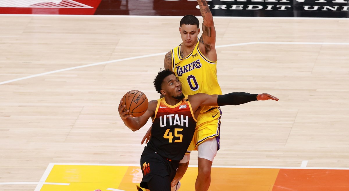 Feb 24, 2021; Salt Lake City, Utah, USA;  Utah Jazz guard Donovan Mitchell (45) tries to get past Los Angeles Lakers forward Kyle Kuzma (0) and to the basket during the third quarter at Vivint Smart Home Arena. Utah Jazz won 114-89. Mandatory Credit: Chris Nicoll-USA TODAY Sports