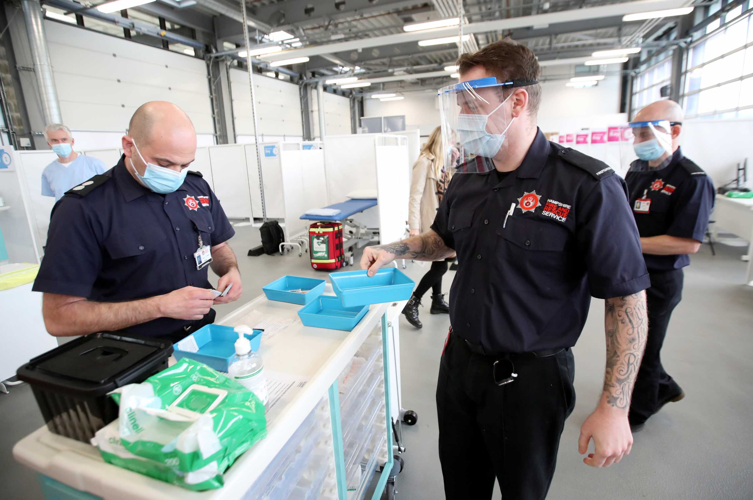 Members of the Hampshire Fire and Rescue Service prepare to vaccine patients with the Oxford-AstraZeneca COVID-19 vaccine at Basingstoke Fire Station, in Basingstoke, Britain February 4, 2021. REUTERS