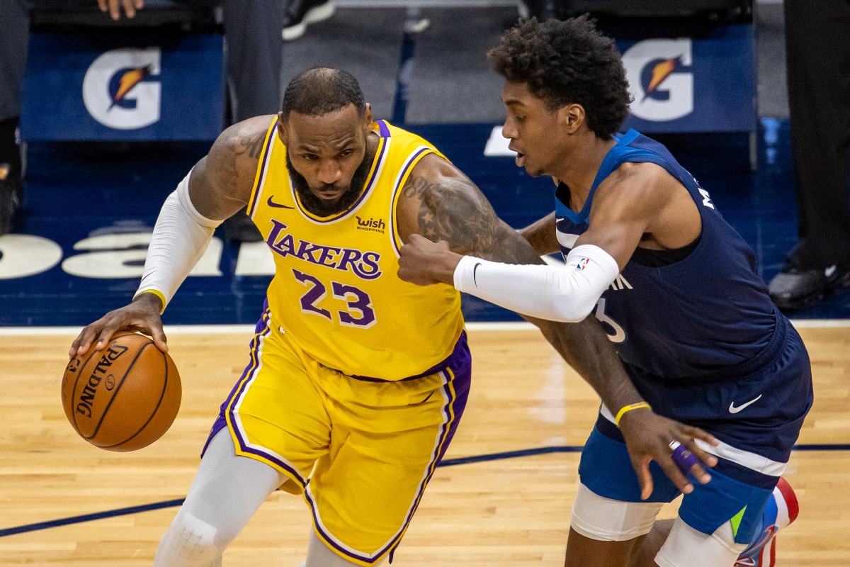 Feb 16, 2021; Minneapolis, Minnesota, USA; Los Angeles Lakers forward LeBron James (23) dribbles the ball against Minnesota Timberwolves forward Jaden McDaniels (3) in the second half at Target Center. Mandatory Credit: Jesse Johnson-USA TODAY Sports