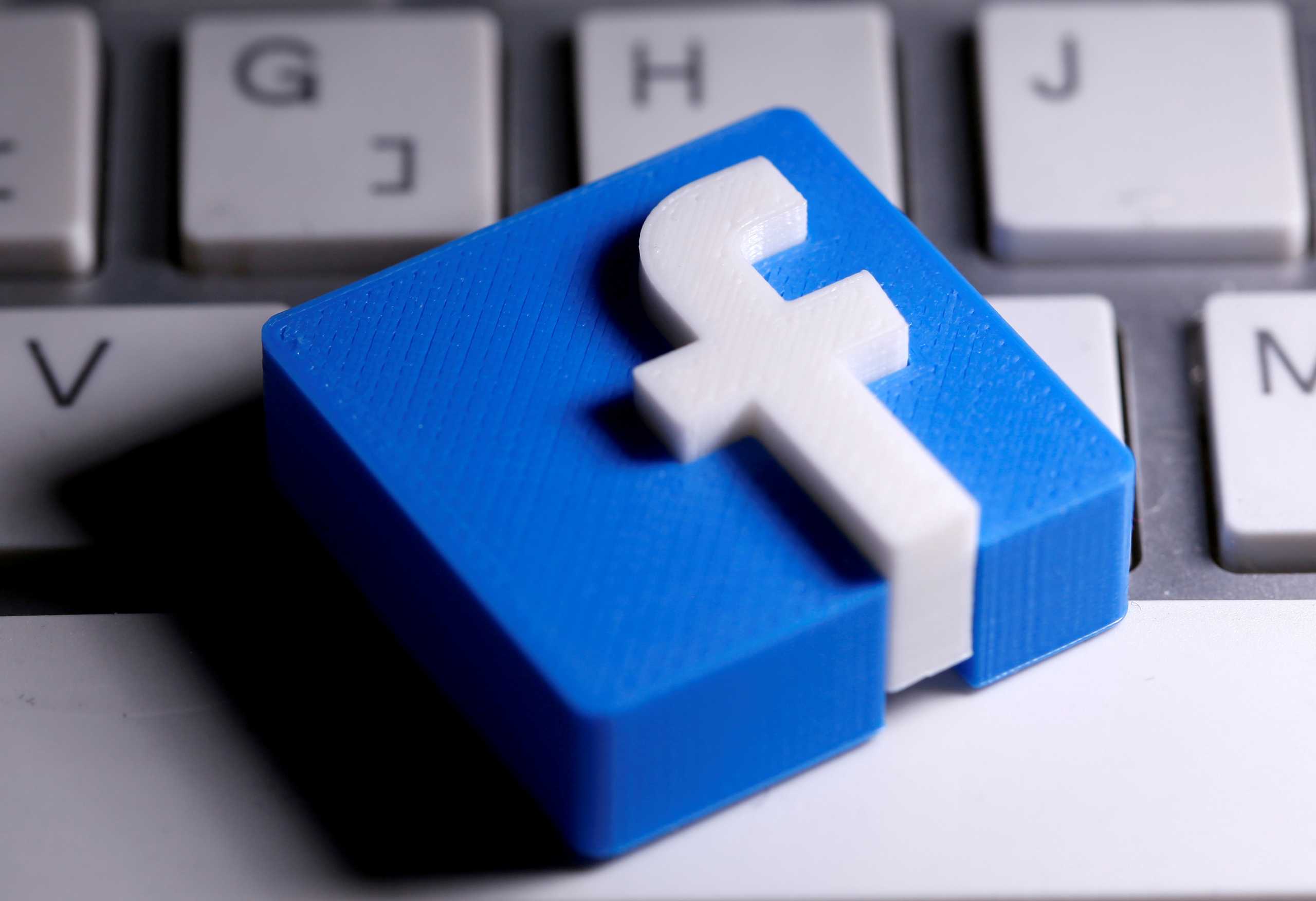 FILE PHOTO: A 3D-printed Facebook logo is seen placed on a keyboard in this illustration taken March 25, 2020. REUTERS