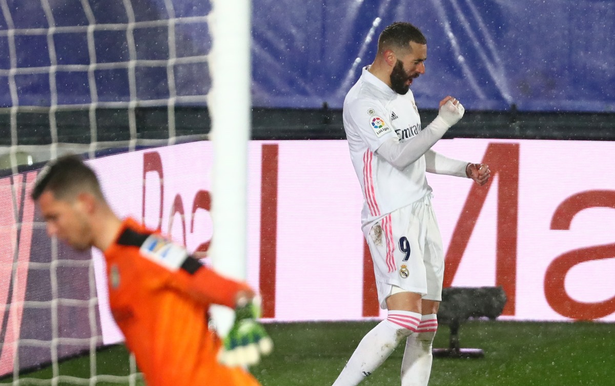Soccer Football - La Liga Santander - Real Madrid v Getafe - Estadio Alfredo Di Stefano, Madrid, Spain - February 9, 2021 Getafe's David Soria looks dejected as Real Madrid's Karim Benzema celebrates scoring their first goal REUTERS