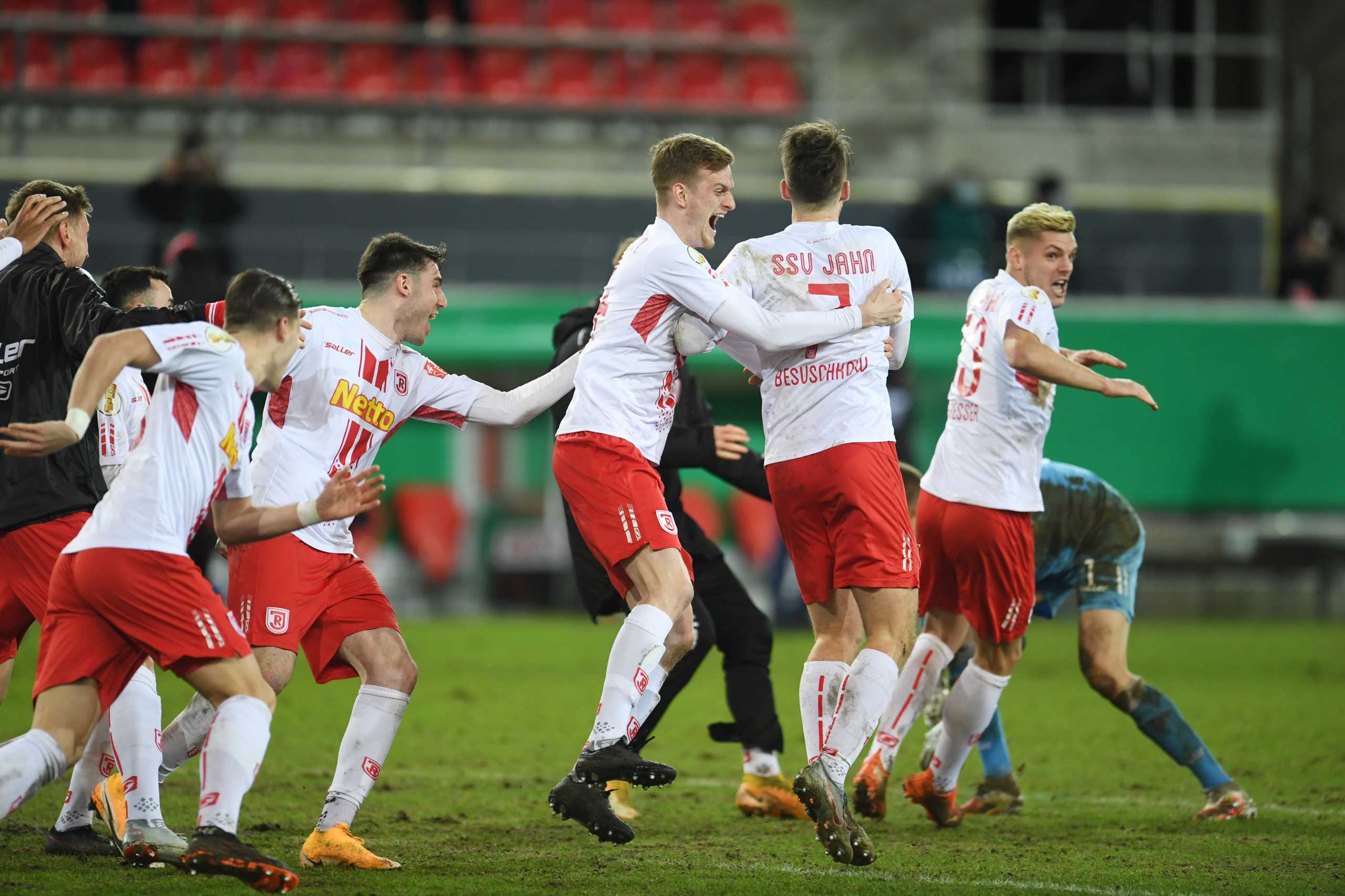 Soccer Football - DFB Cup - Third Round - Jahn Regensburg v FC Cologne - Jahnstadion Regensburg, Regensburg, Germany - February 3, 2021 Jahn Regensburg players celebrate after the match REUTERS