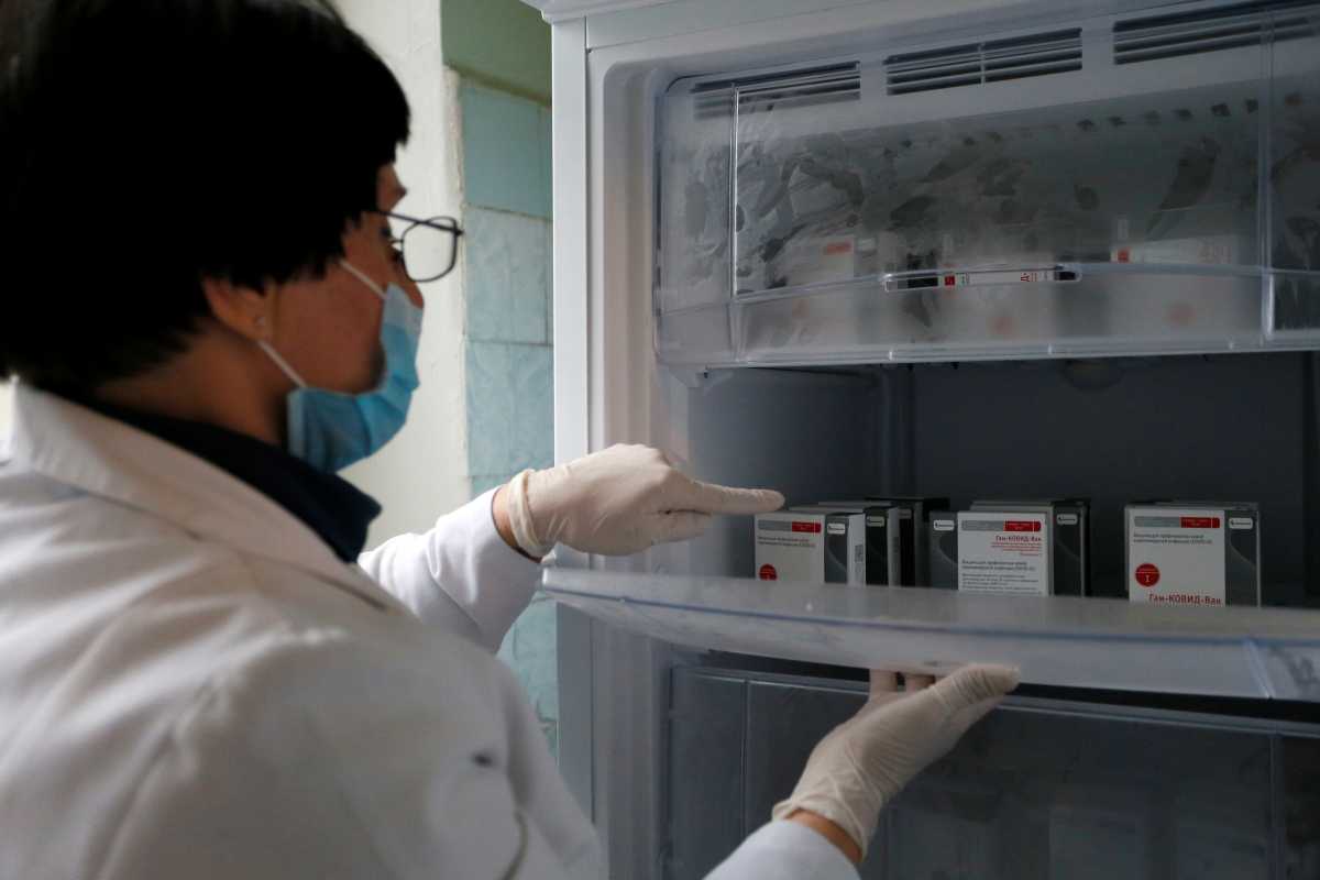 A medical worker places boxes of the?Sputnik?V (Gam-COVID-Vac) vaccine against the coronavirus disease (COVID-19) in the fridge at a hospital in the rebel-controlled city of Donetsk, Ukraine January 31, 2021. REUTERS