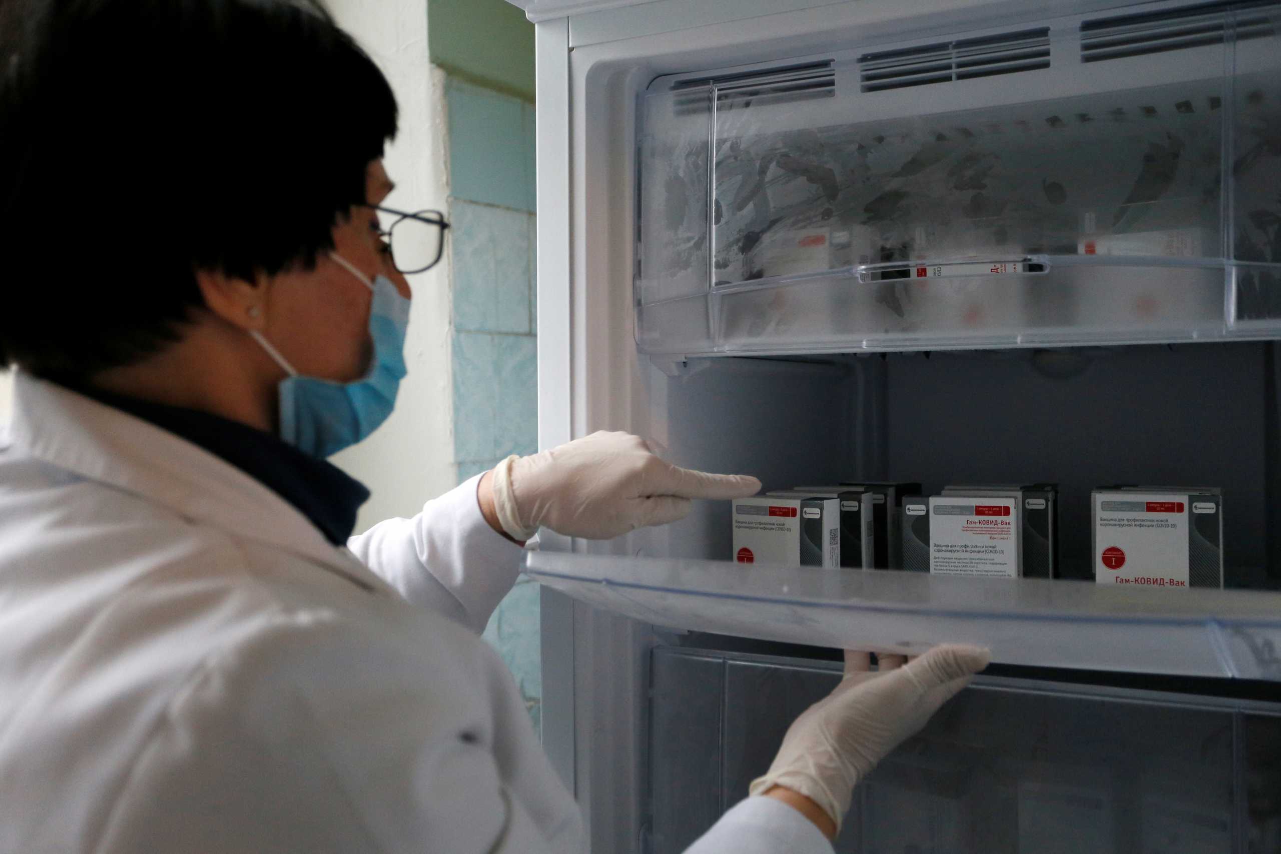 A medical worker places boxes of the?Sputnik?V (Gam-COVID-Vac) vaccine against the coronavirus disease (COVID-19) in the fridge at a hospital in the rebel-controlled city of Donetsk, Ukraine January 31, 2021. REUTERS
