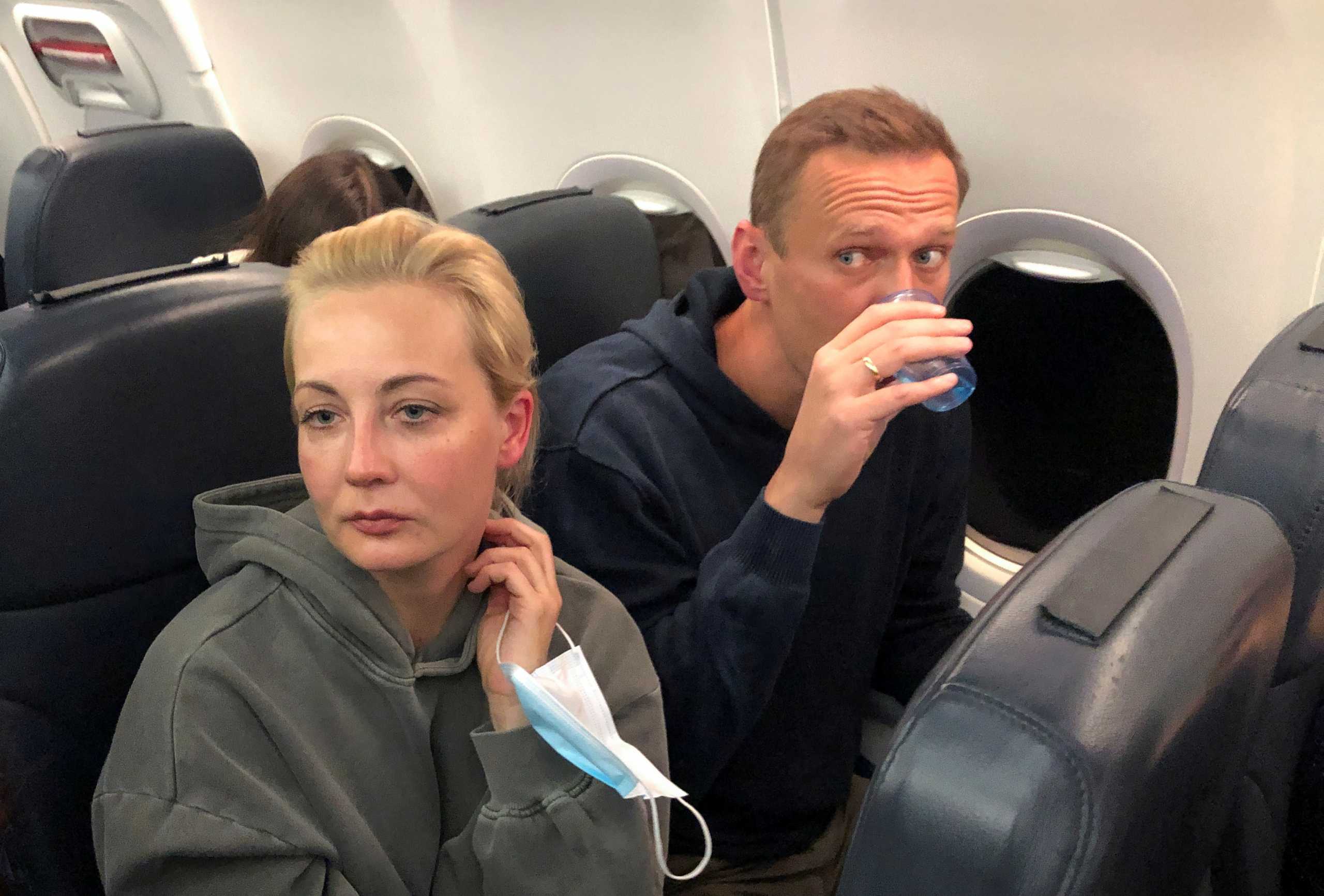 Russian opposition leader Alexei Navalny and his wife Yulia Navalnaya are seen on board a plane during a flight from Berlin to Moscow, January 17, 2021. REUTERS