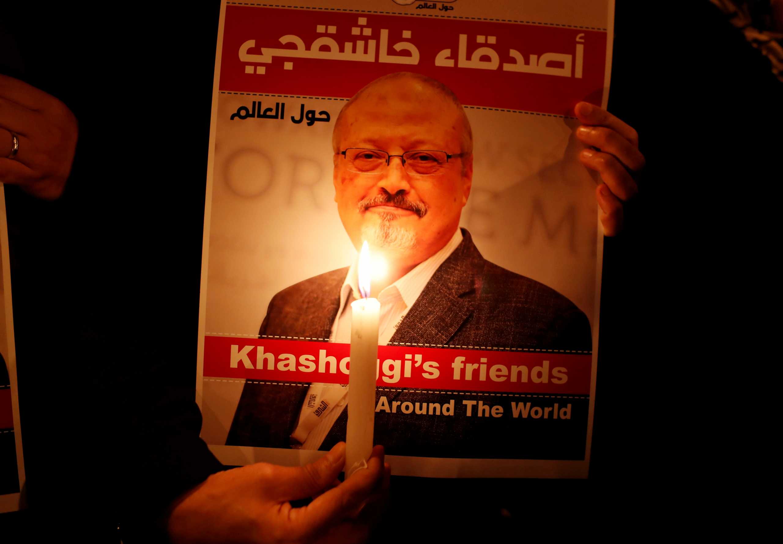 FILE PHOTO: A demonstrator holds a poster with a picture of Saudi journalist Jamal Khashoggi outside the Saudi Arabia consulate in Istanbul, Turkey October 25, 2018. REUTERS