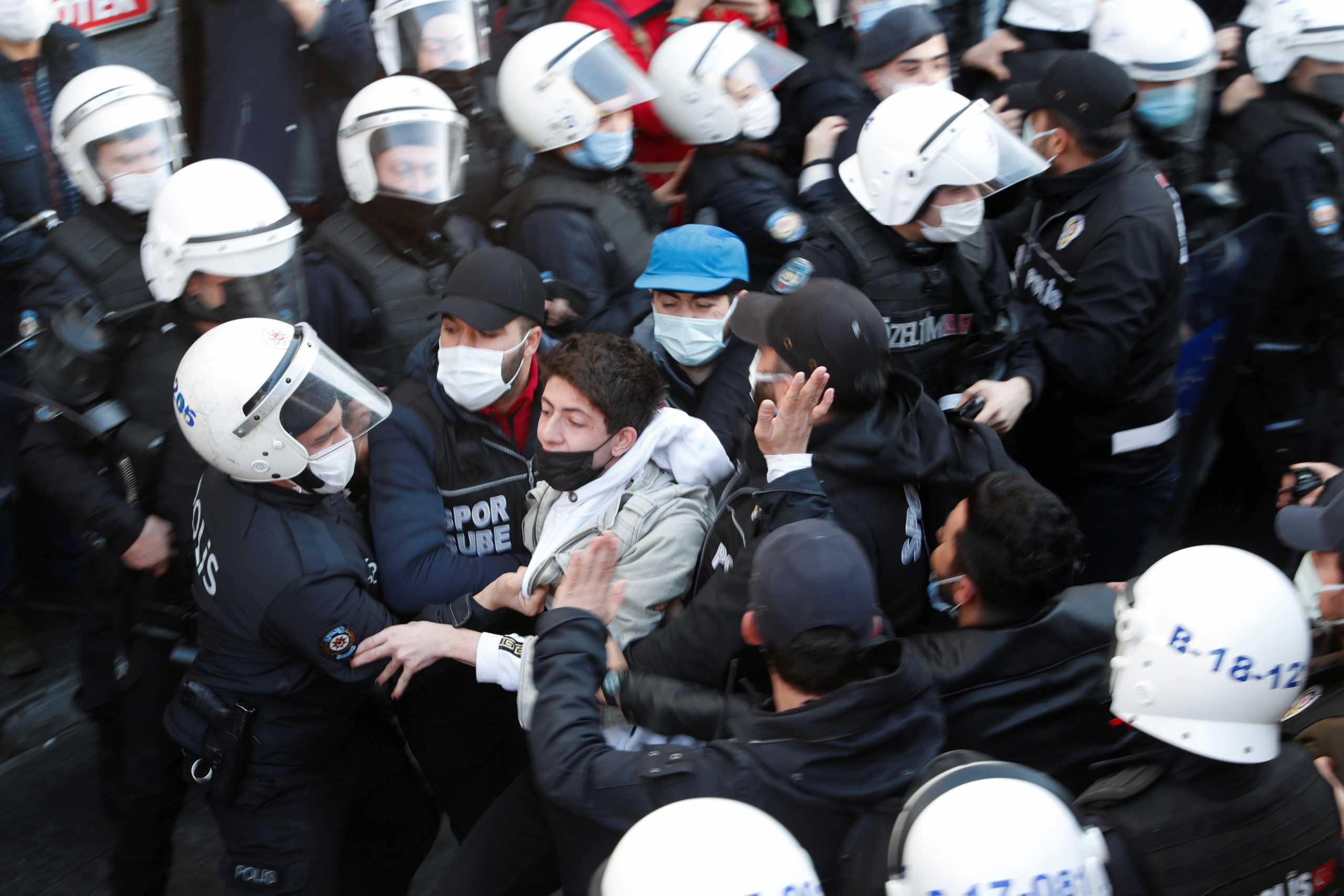 Supporters of the pro-Kurdish Peoples' Democratic Party (HDP) scuffle with police officers as they gather to support Bogazici University students who are protesting against the appointment of Melih Bulu as the new rector of the university, in Istanbul, Turkey, February 4, 2021. REUTERS