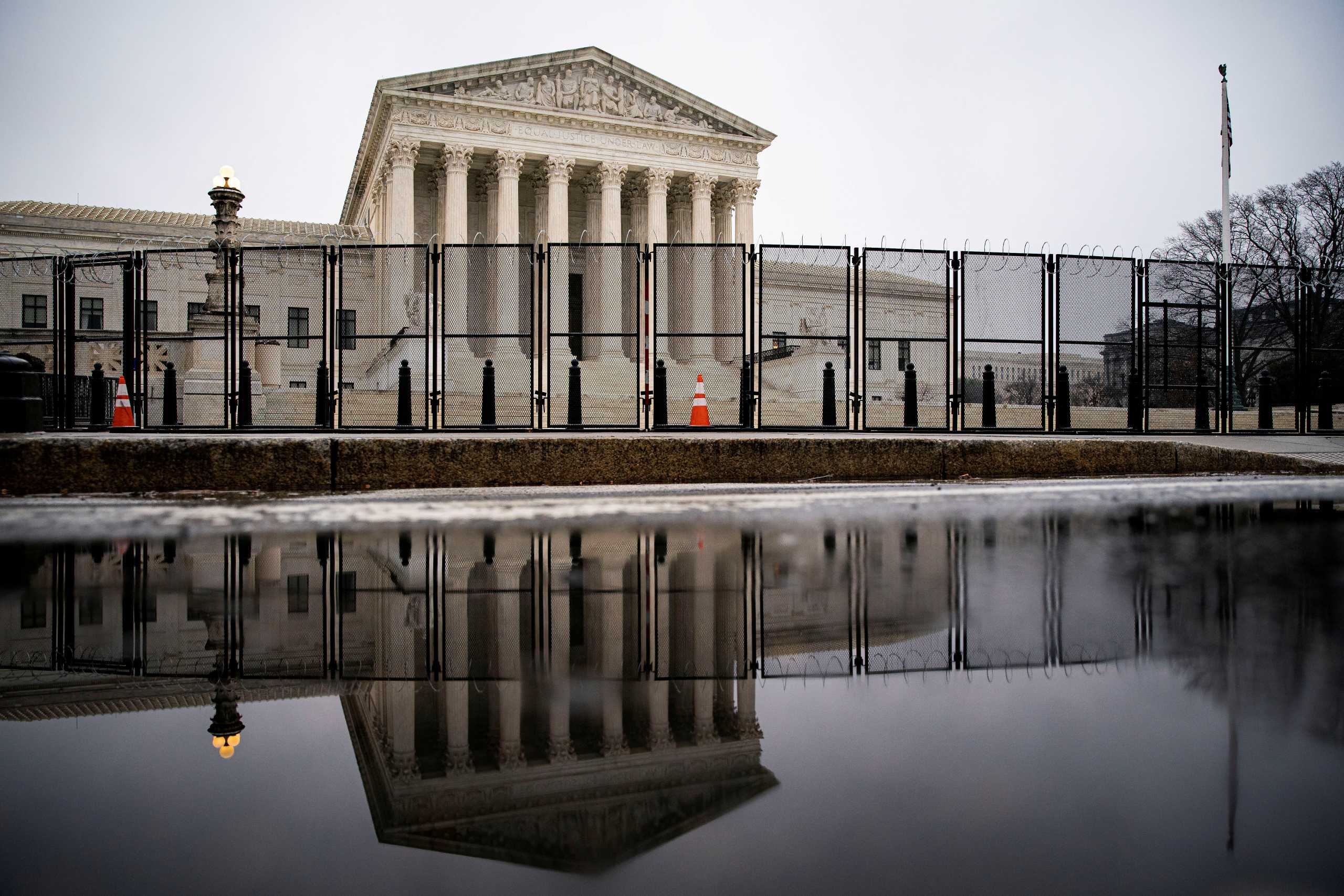 FILE PHOTO: Barbed wire and security fencing surrounds the U.S. Supreme Court in Washington, U.S., January 26, 2021. REUTERS