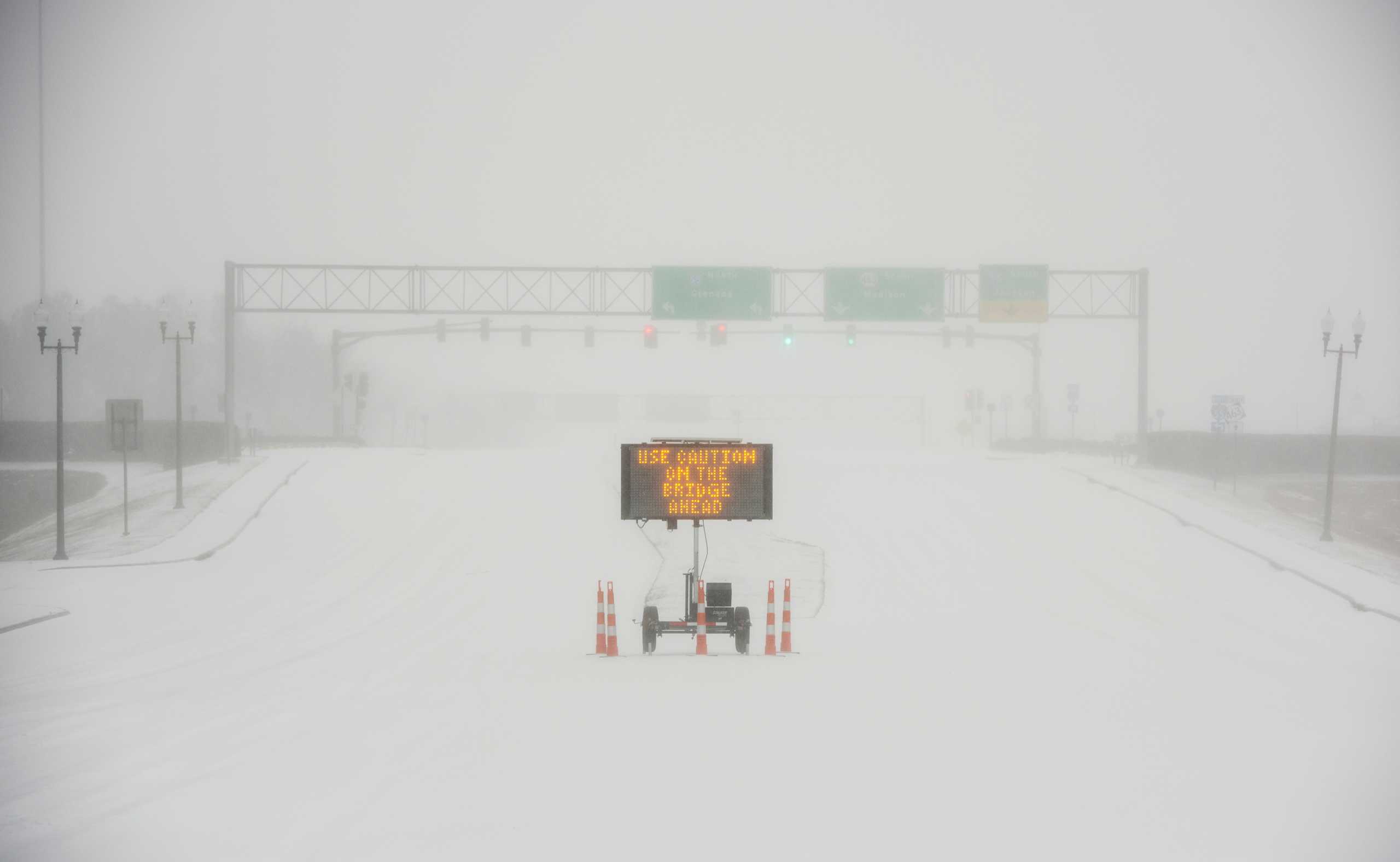 A sign warns motorists after a sudden heavy bout of snow and frozen rain on MS Highway 463 in Madison, north of Jackson, Mississippi, U.S. February 15, 2021.  Barbara Gauntt