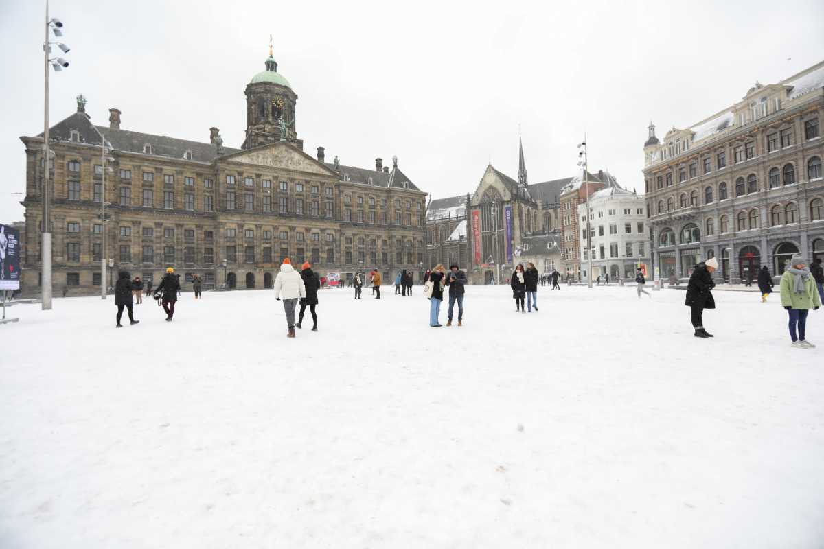 People walk after heavy snowfall in Amsterdam, Netherlands February 7, 2021. REUTERS