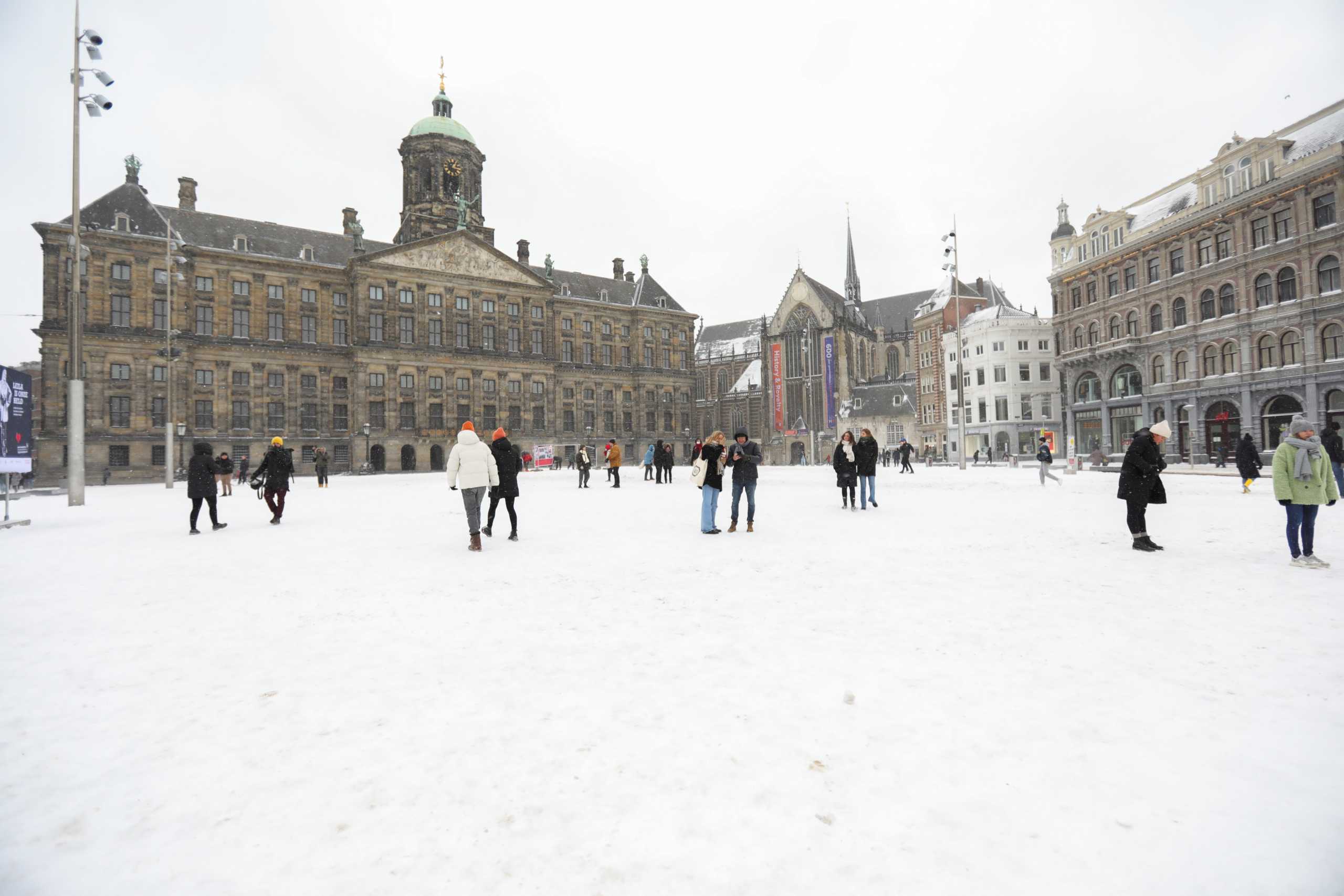People walk after heavy snowfall in Amsterdam, Netherlands February 7, 2021. REUTERS