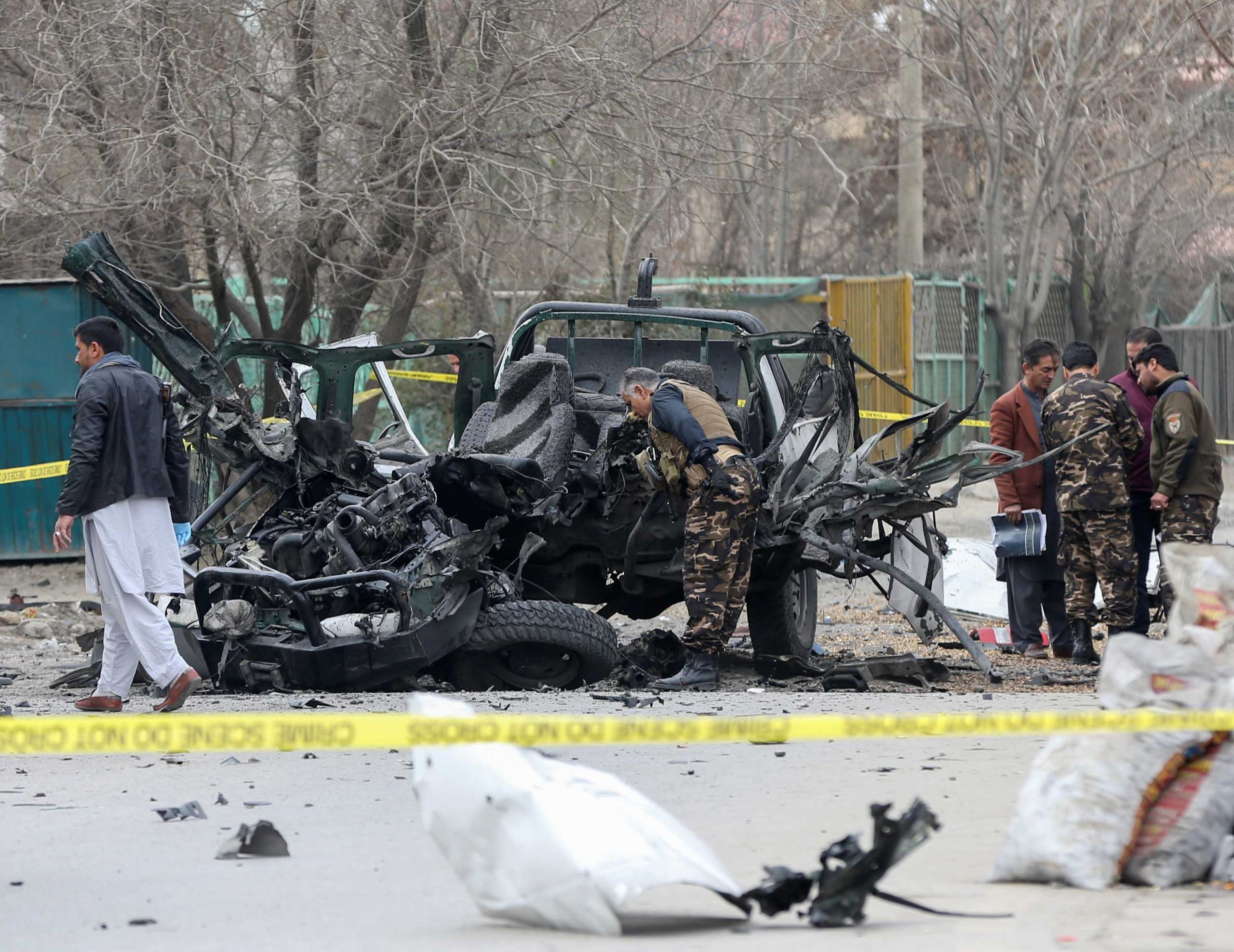 Afghan security forces inspect the site of a bomb blast in Kabul, Afghanistan February 20, 2021. REUTERS