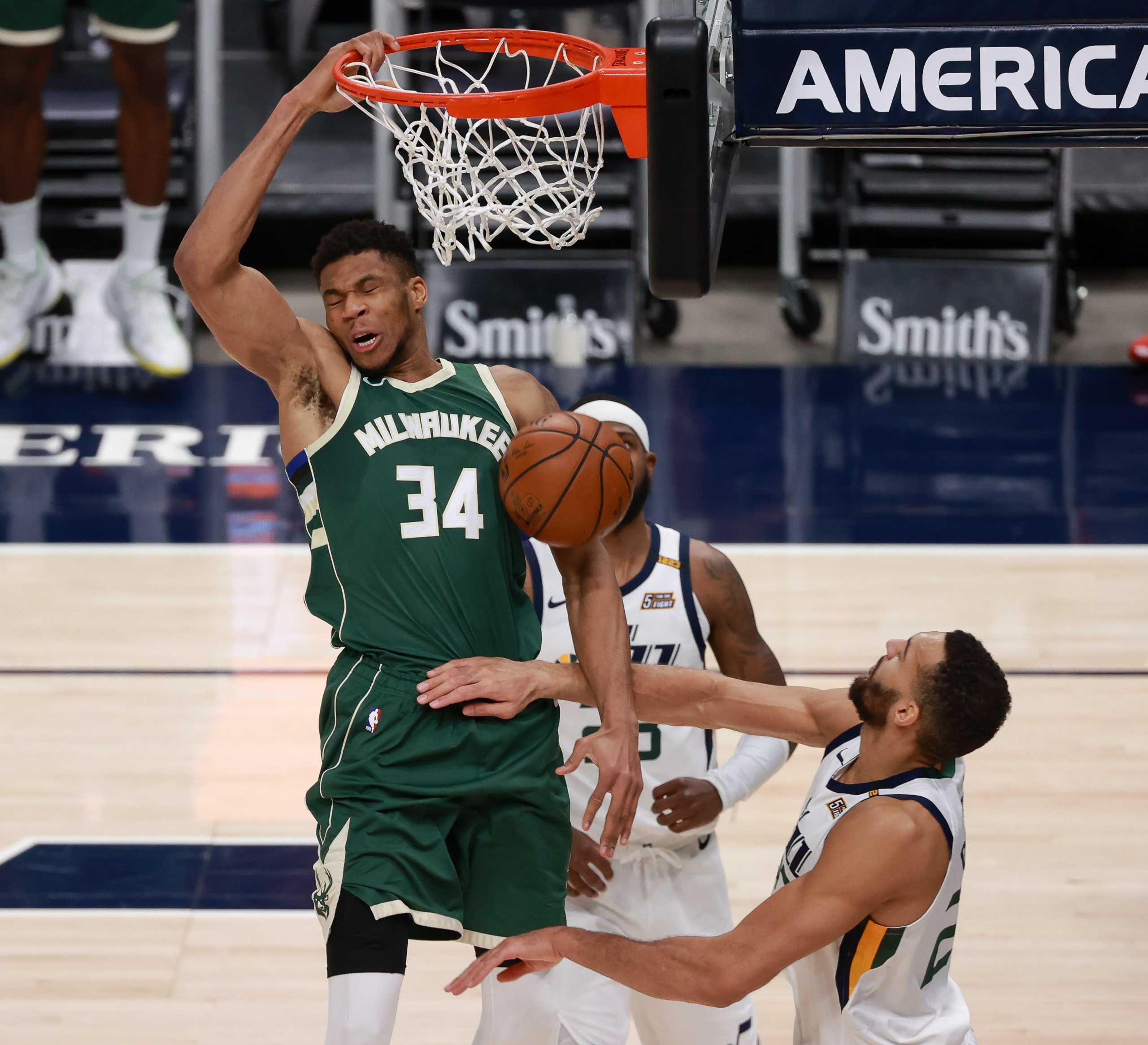 Feb 12, 2021; Salt Lake City, Utah, USA; Milwaukee Bucks forward Giannis Antetokounmpo (34) dunks the ball over Utah Jazz center Rudy Gobert (27) during the fourth quarter at Vivint Smart Home Arena. Utah Jazz win 129-115. Mandatory Credit: Chris Nicoll-USA TODAY Sports