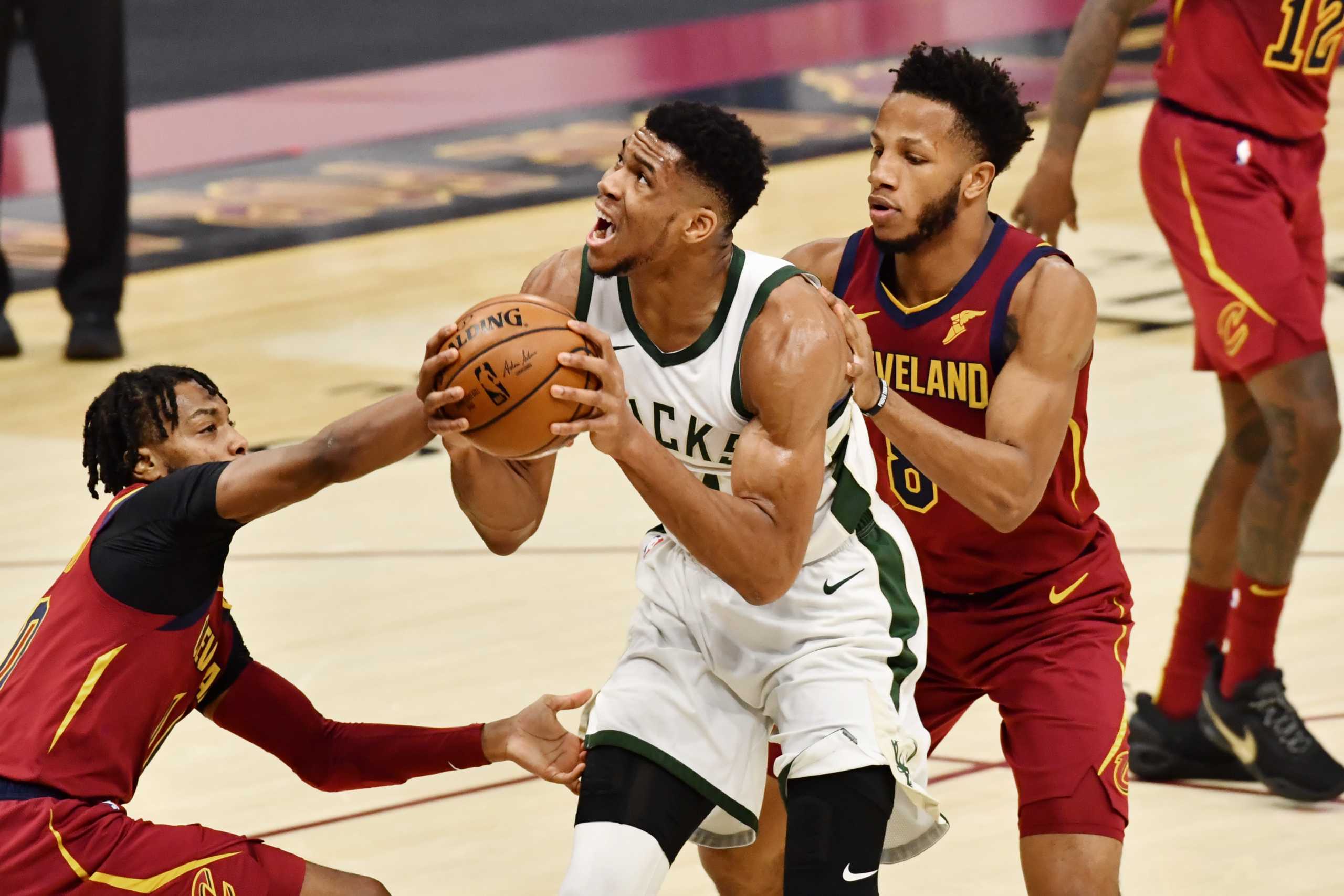 Feb 5, 2021; Cleveland, Ohio, USA; Milwaukee Bucks forward Giannis Antetokounmpo (34) drives to the basket between Cleveland Cavaliers guard Darius Garland (10) and forward Lamar Stevens (8) during the third quarter at Rocket Mortgage FieldHouse. Mandatory Credit: Ken Blaze-USA TODAY Sports