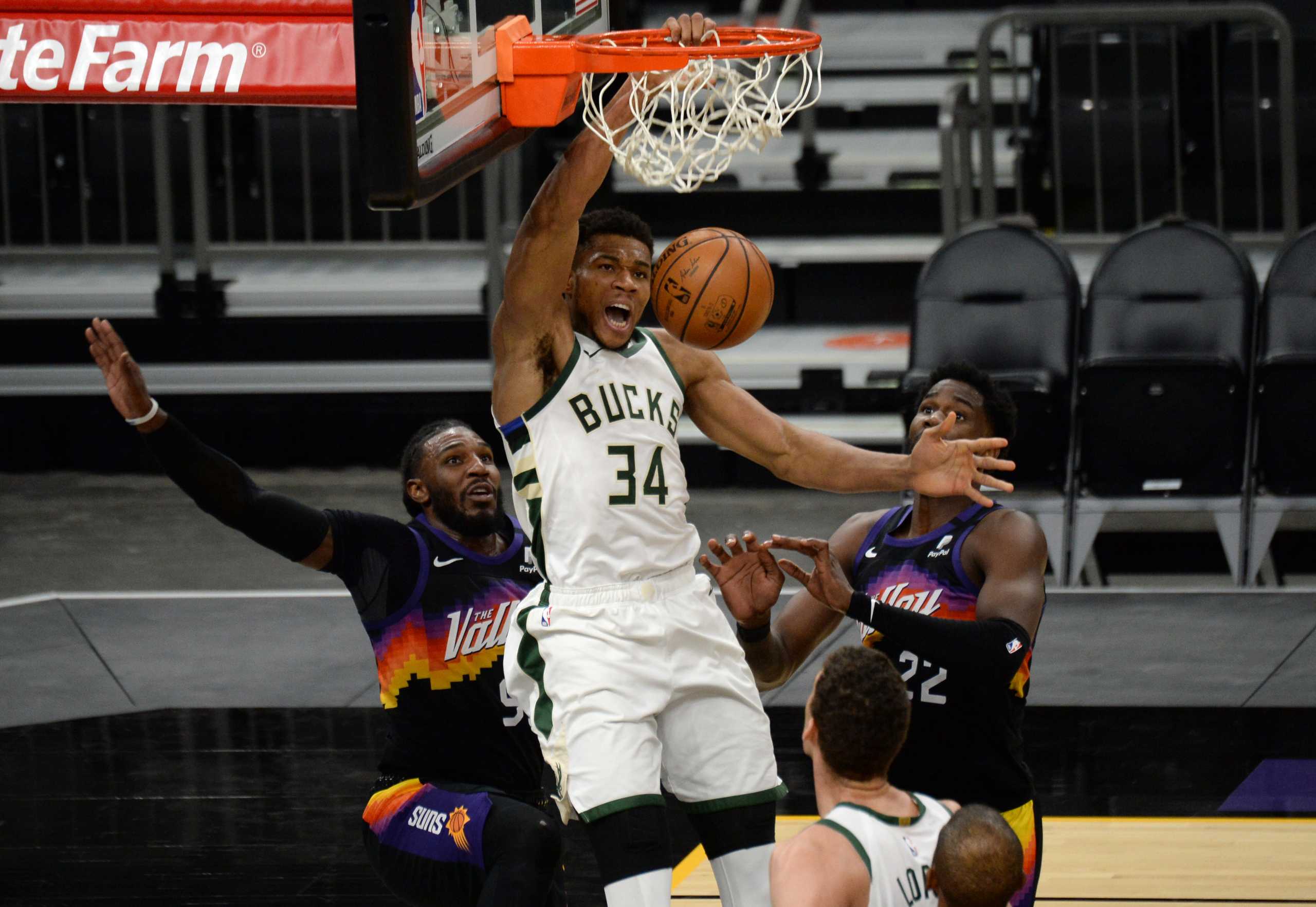Feb 10, 2021; Phoenix, Arizona, USA; Milwaukee Bucks forward Giannis Antetokounmpo (34) dunks against Phoenix Suns forward Jae Crowder (99) and center Deandre Ayton (22) during the second half at Phoenix Suns Arena. Mandatory Credit: Joe Camporeale-USA TODAY Sports