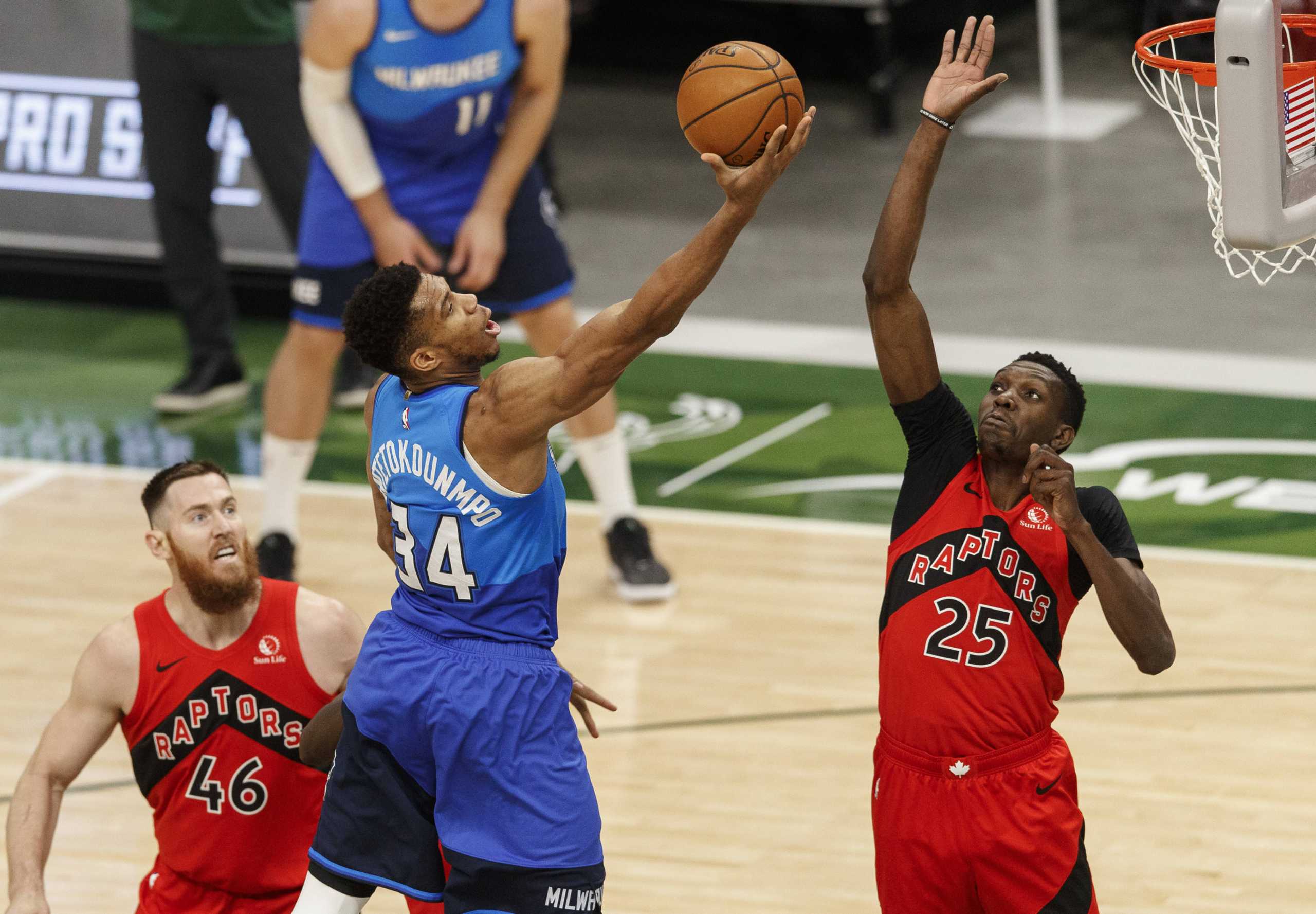 Feb 18, 2021; Milwaukee, Wisconsin, USA;  Milwaukee Bucks forward Giannis Antetokounmpo (34) shoots against Toronto Raptors forward Chris Boucher (25) during the second quarter at Fiserv Forum. Mandatory Credit: Jeff Hanisch-USA TODAY Sports
