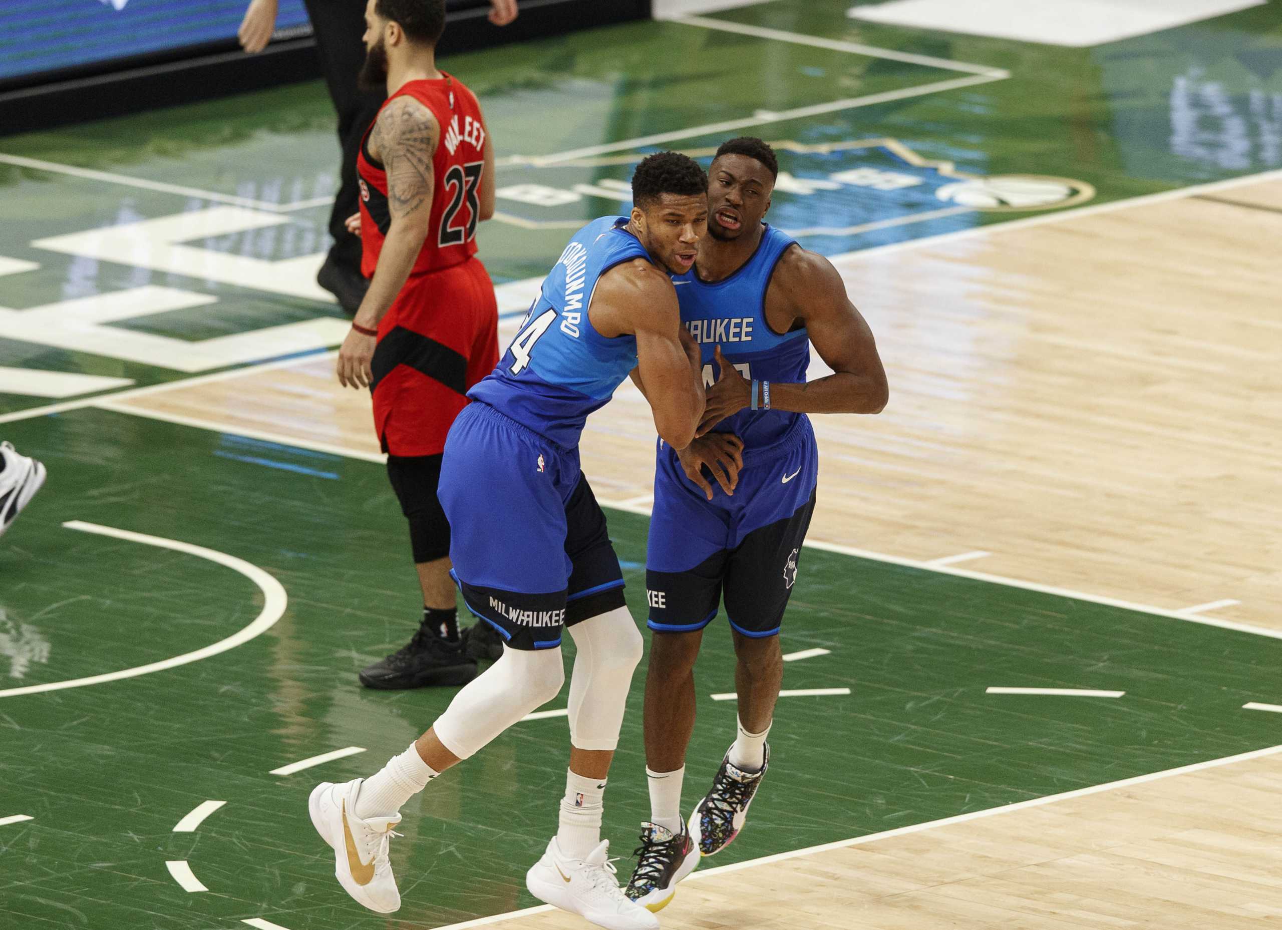 Feb 18, 2021; Milwaukee, Wisconsin, USA; Milwaukee Bucks forward Thanasis Antetokounmpo (43) celebrates a basket with forward Giannis Antetokounmpo (34) during the third quarter against the Toronto Raptors at Fiserv Forum. Mandatory Credit: Jeff Hanisch-USA TODAY Sports