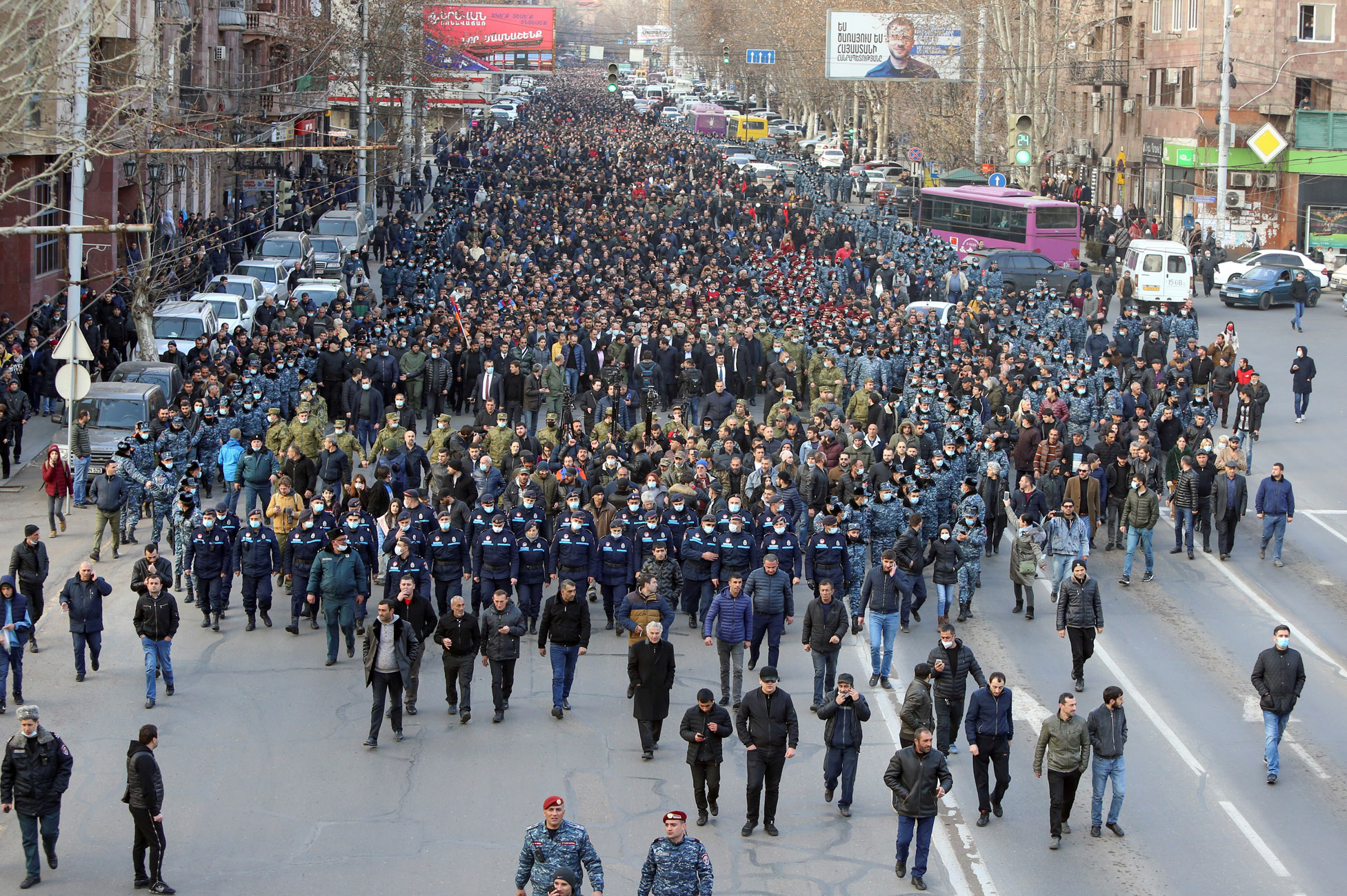 Armenian Prime Minister Nikol Pashinyan and his supporters escorted by law enforcement officers march during a rally in Yerevan, Armenia February 25, 2021. Stepan Poghosyan