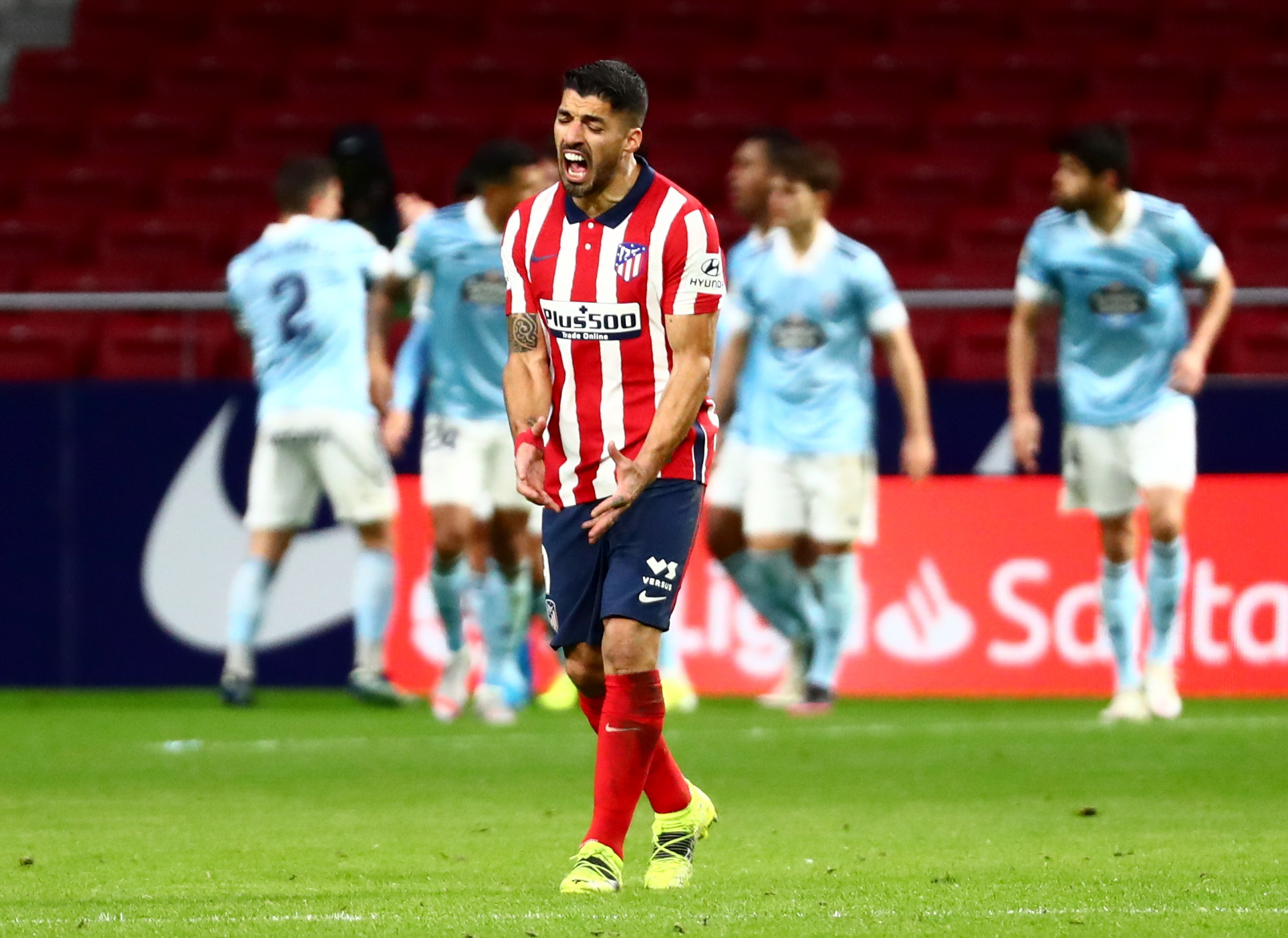 Soccer Football - La Liga Santander - Atletico Madrid v Celta Vigo - Wanda Metropolitano, Madrid, Spain - February 8, 2021 Atletico Madrid's Luis Suarez looks dejected as Celta Vigo's Facundo Ferreyra celebrates scoring their second goal with teammates REUTERS