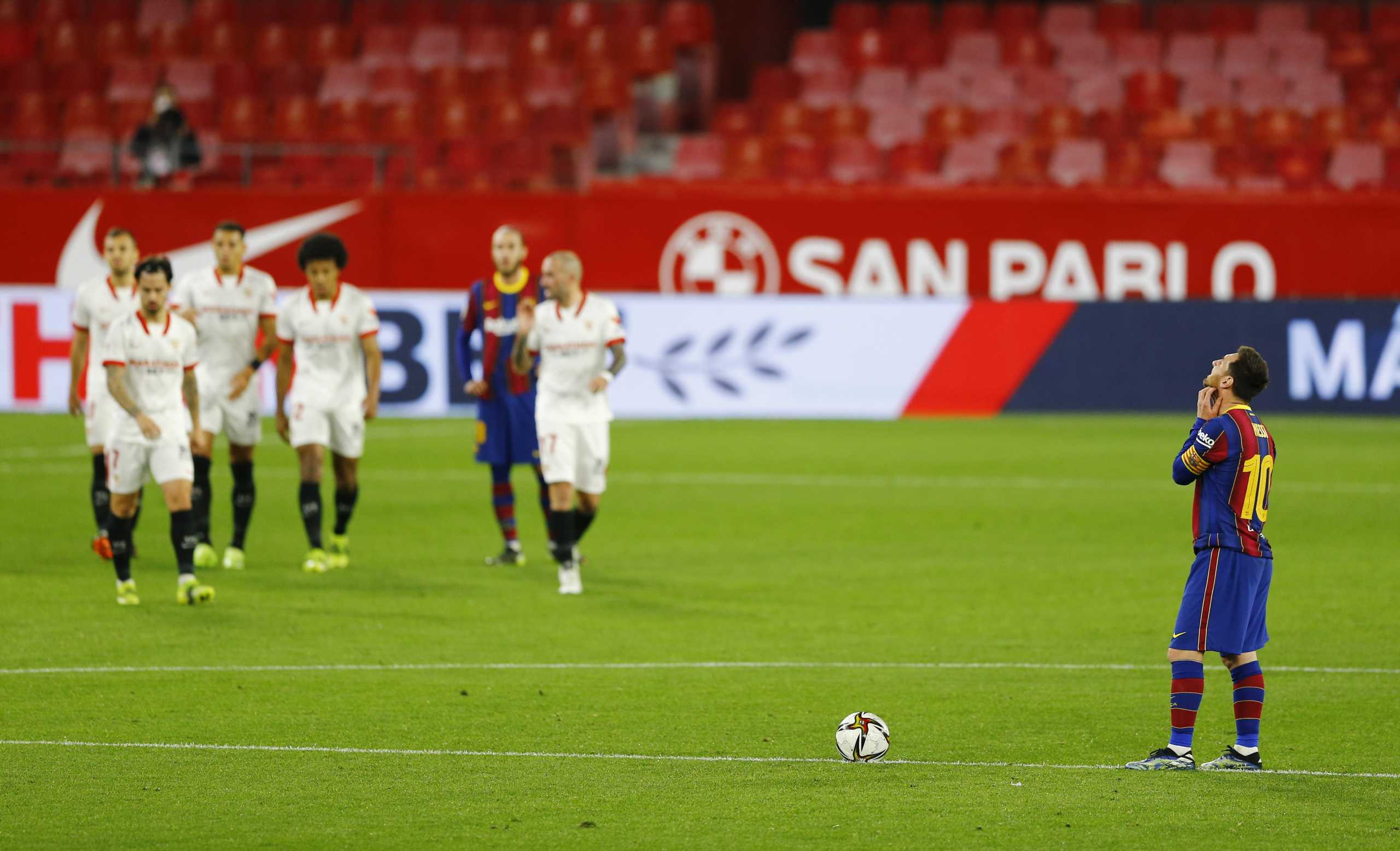 Soccer Football - Copa del Rey - Semi Final First Leg - Sevilla v FC Barcelona - Ramon Sanchez Pizjuan, Seville, Spain - February 10, 2021 Barcelona's Lionel Messi looks dejected as he waits to restart the match after Sevilla's Jules Kounde scored the first goal REUTERS