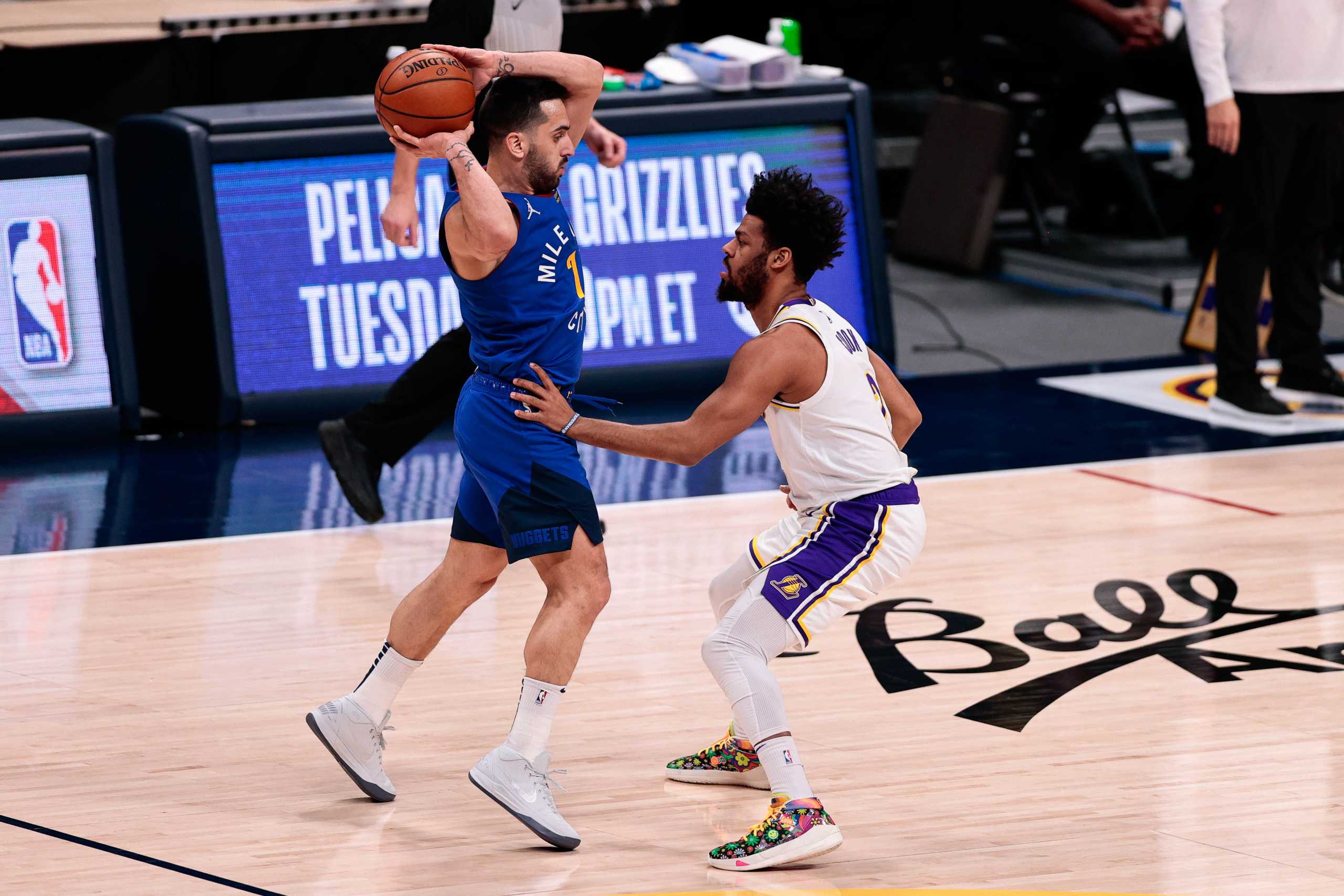 Feb 14, 2021; Denver, Colorado, USA; Denver Nuggets guard Facundo Campazzo (7) controls the ball as Los Angeles Lakers guard Quinn Cook (2) guards in the fourth quarter at Ball Arena. Mandatory Credit: Isaiah J. Downing-USA TODAY Sports