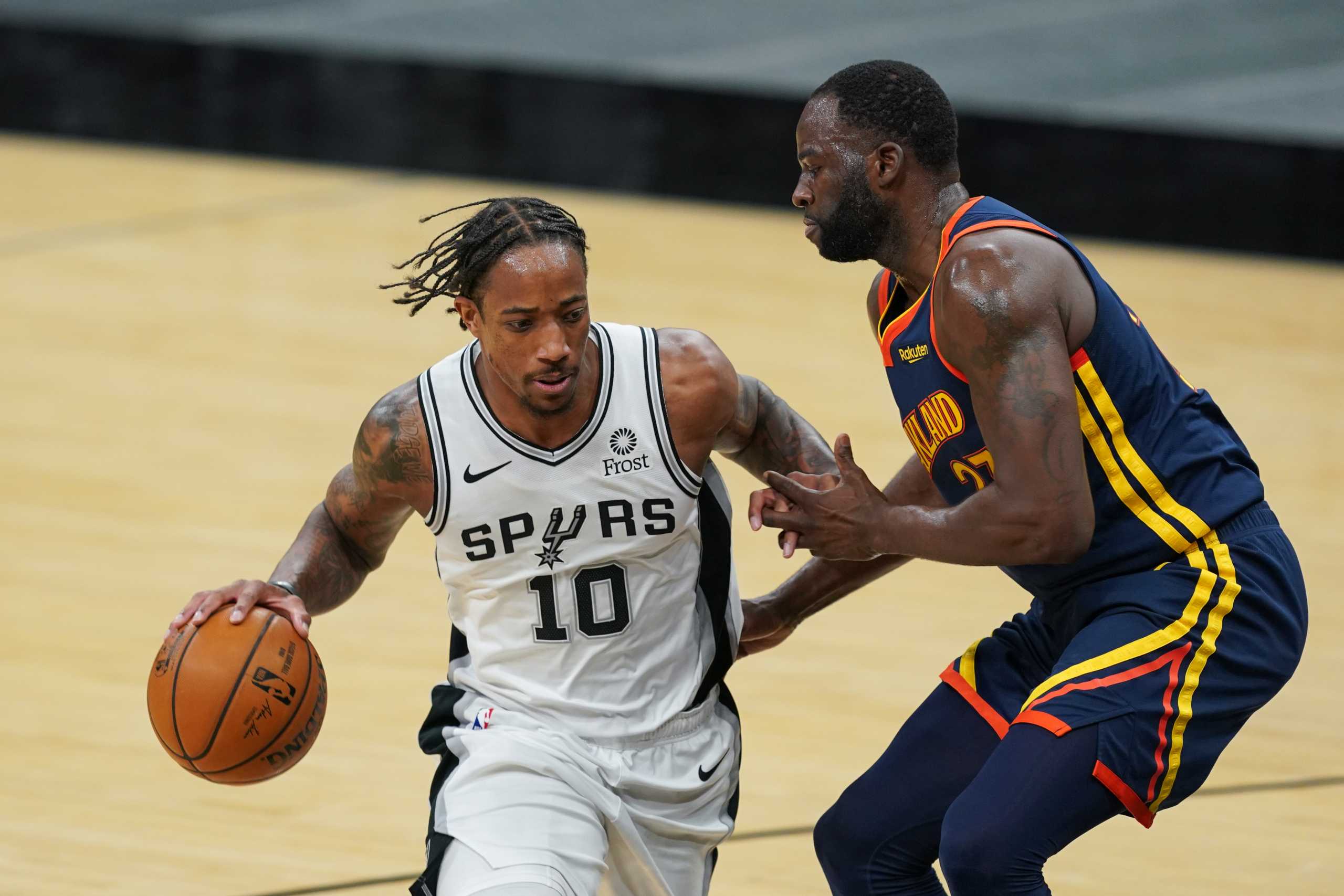 Feb 8, 2021; San Antonio, Texas, USA;  San Antonio Spurs forward DeMar DeRozan (10) dribbles past Golden State Warriors forward Draymond Green (23) in the first half at the AT&T Center. Mandatory Credit: Daniel Dunn-USA TODAY Sports