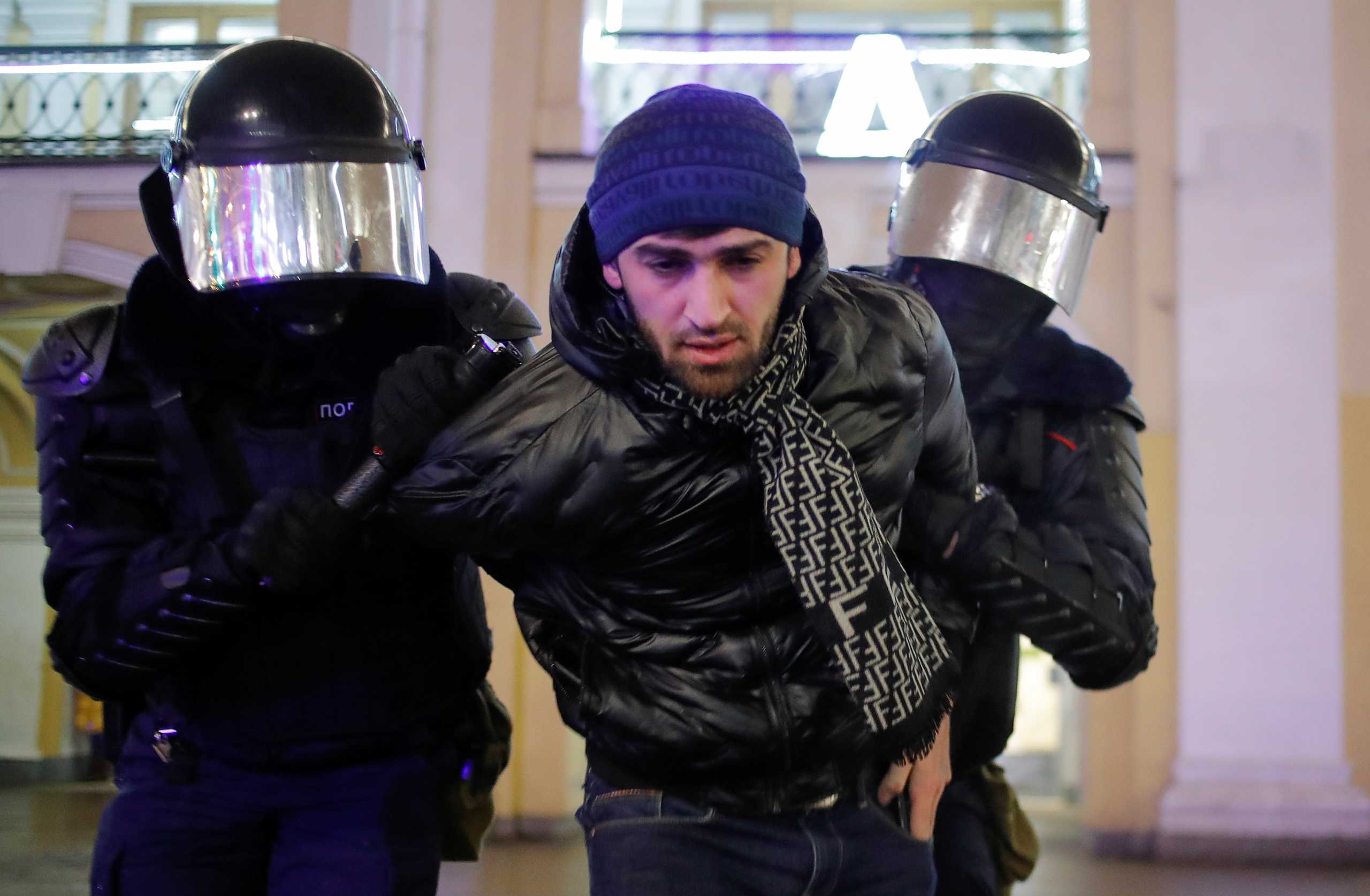 Law enforcement officers detain a man during a gathering in a street, after a Moscow court sentenced Russian opposition leader Alexei Navalny to three and a half years in jail for violating the terms of his parole, in Saint Petersburg, Russia February 2, 2021. REUTERS