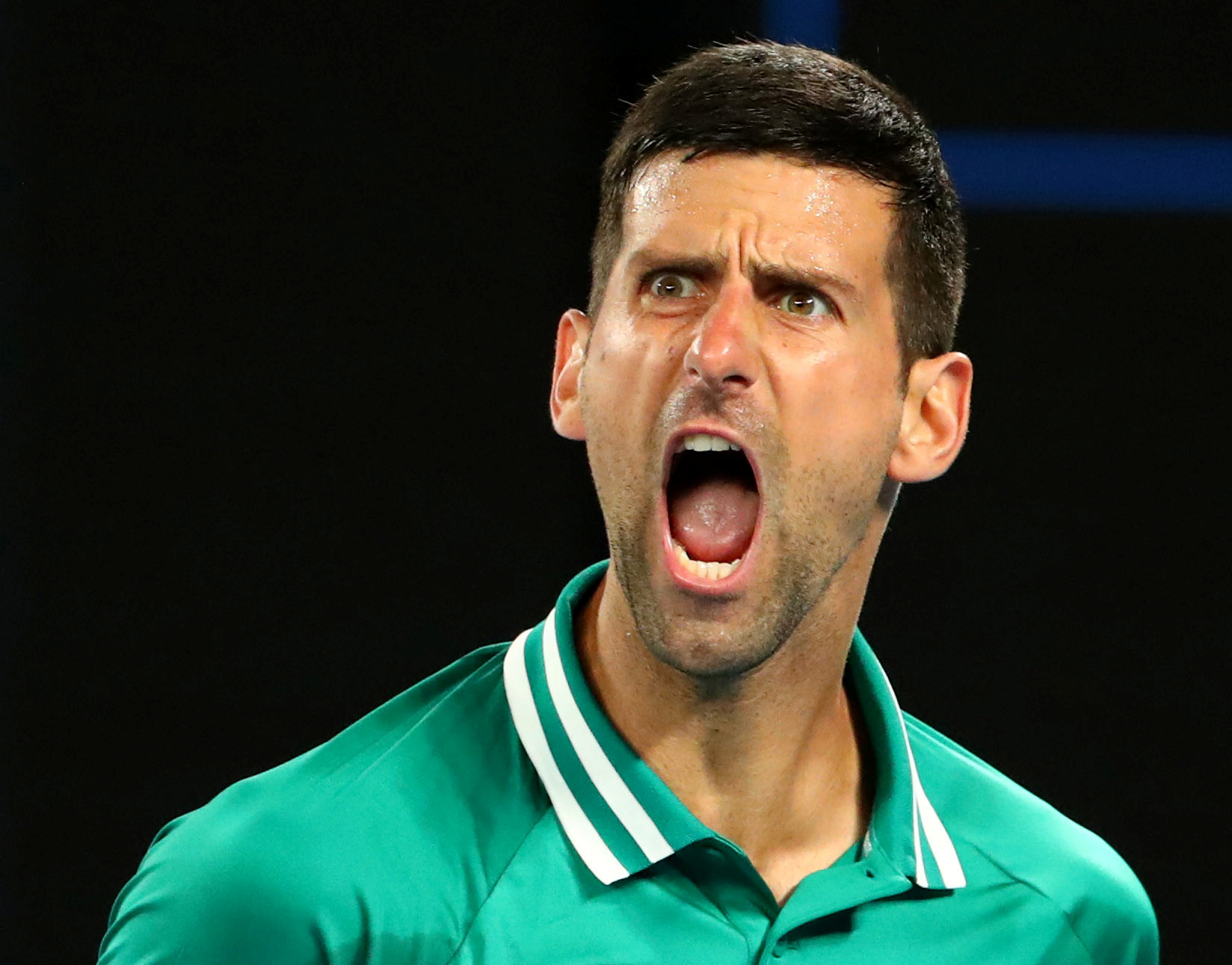 Tennis - Australian Open - Melbourne Park, Melbourne, Australia, February 12, 2021 Serbia's Novak Djokovic reacts during his third round match against Taylor Fritz of the U.S. REUTERS