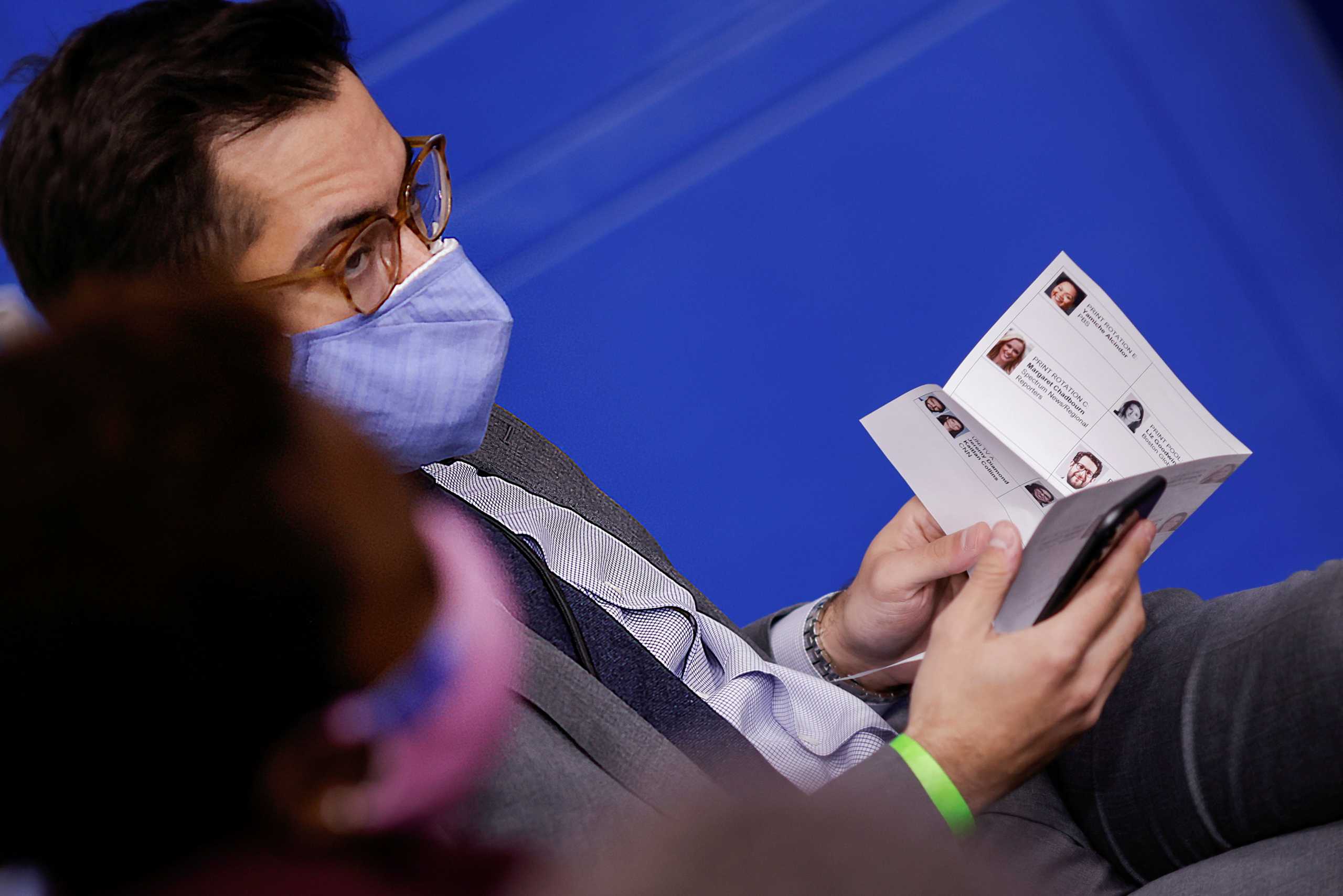 White House Deputy Press Secretary TJ Ducklo holds a paper sheet with names and headshots of reporters during a press briefing at the White House, in Washington, U.S., February 8, 2021. Picture taken on February 8, 2021. REUTERS
