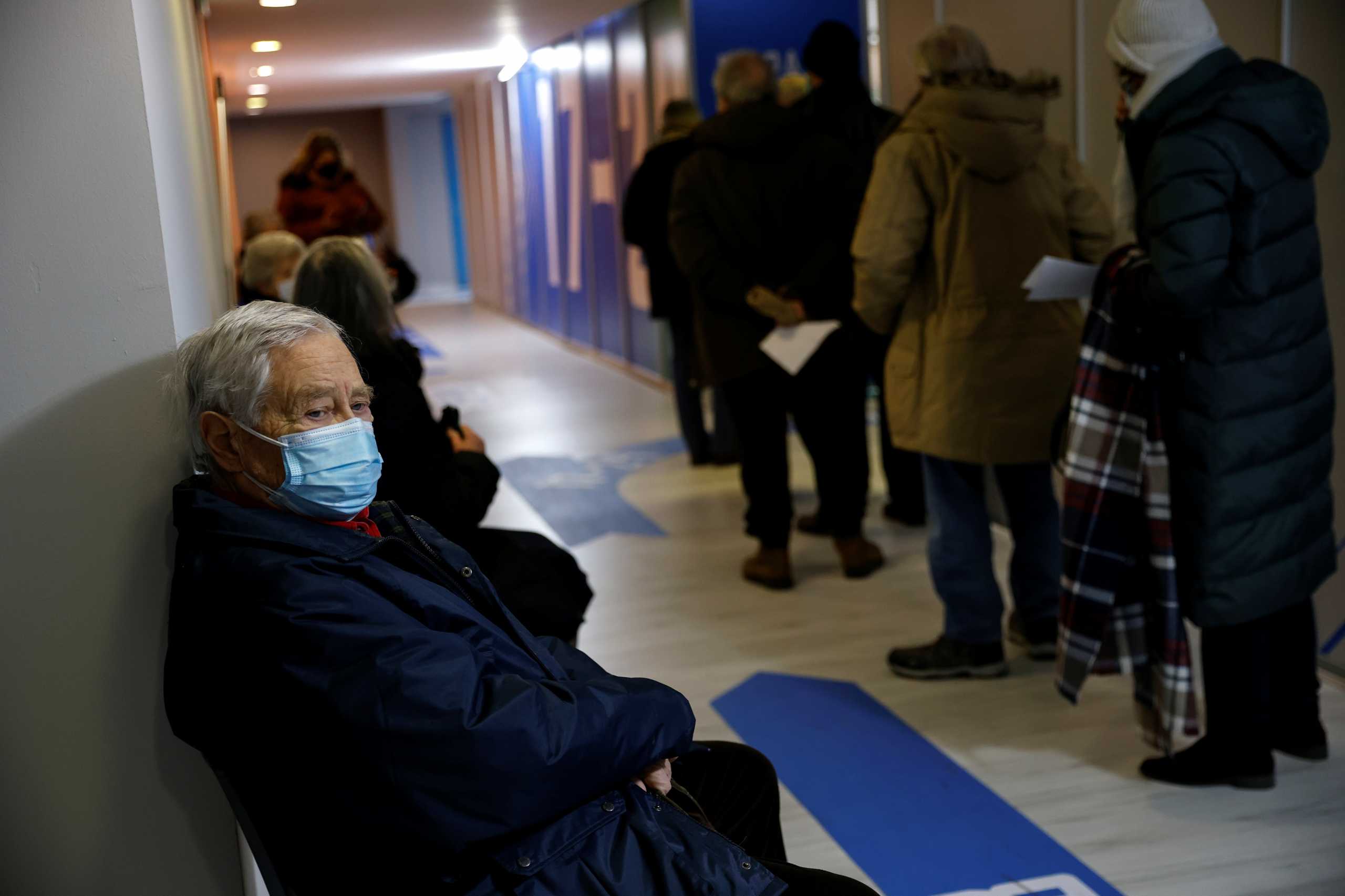 People wait to receive a dose of the Moderna vaccine against the coronavirus disease (COVID-19) at a newly-opened vaccination centre in Athens, Greece, February 15, 2021. REUTERS