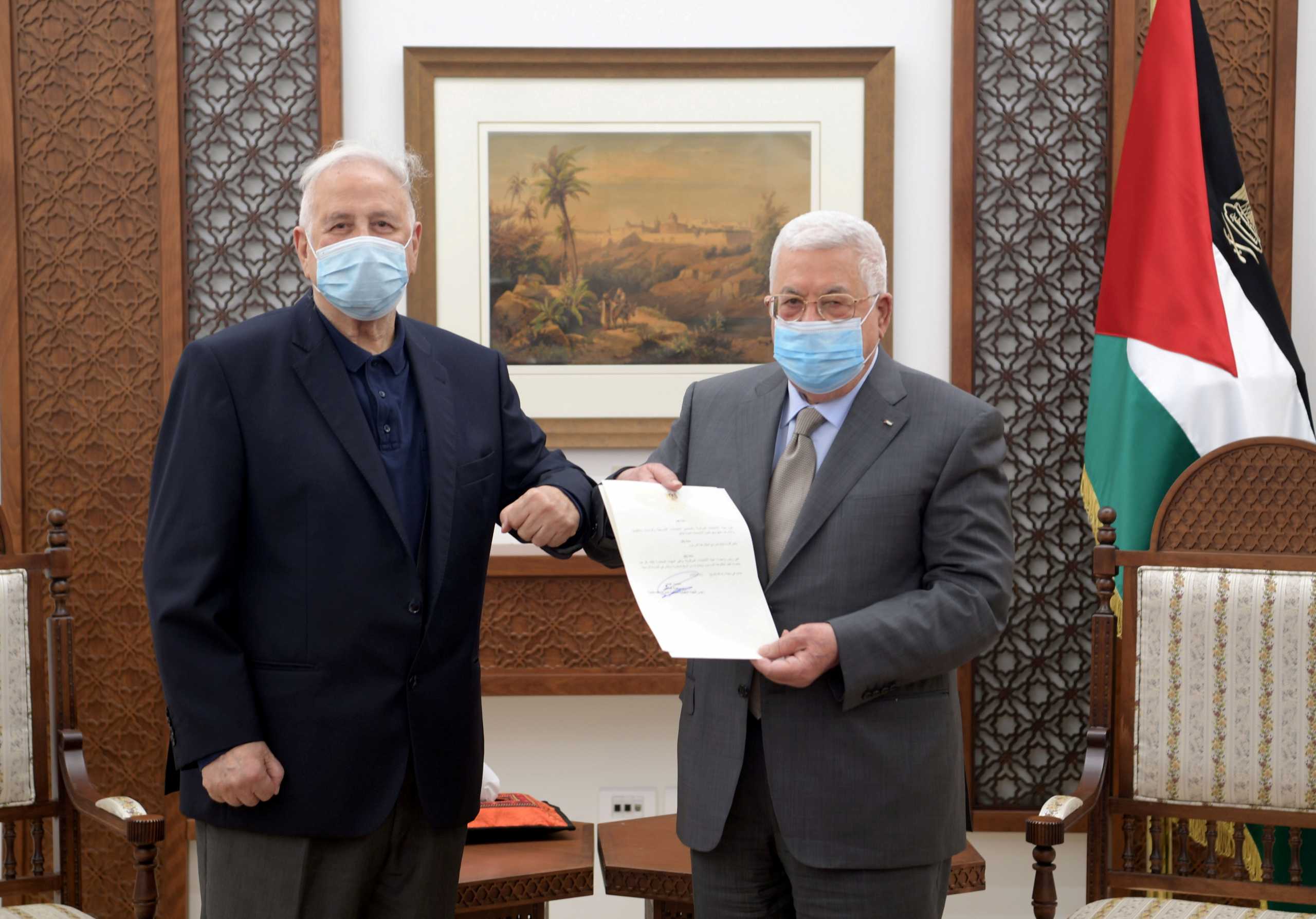 FILE PHOTO: Palestinian President Mahmoud Abbas hands the election decree to Chairman of the Palestinian Central Election Committee Hana Naser in Ramallah in the Israeli-occupied West Bank January 15, 2021. Palestinian President Office (PPO)