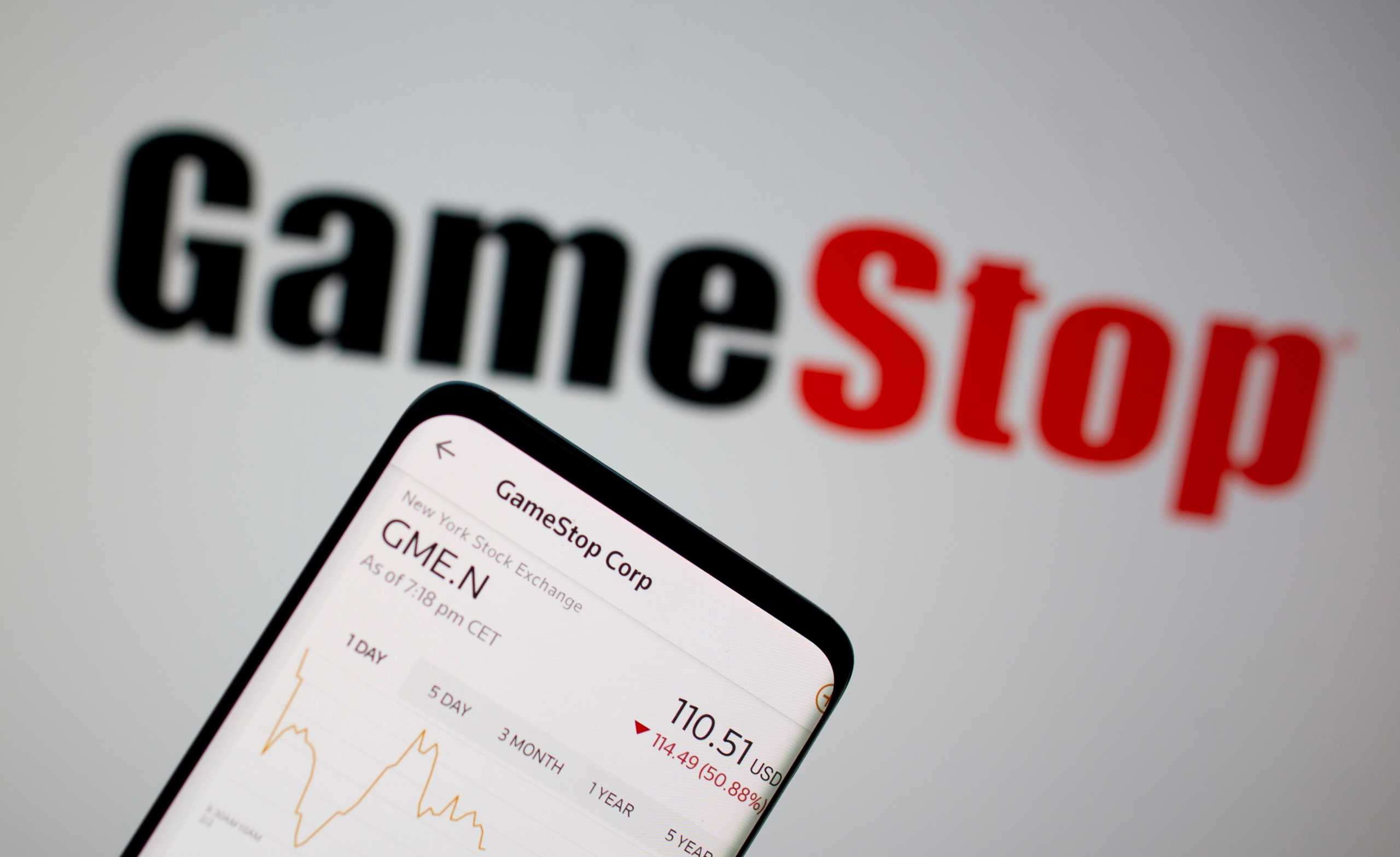 FILE PHOTO: GameStop stock graph is seen in front of the company's logo in this illustration taken February 2, 2021. REUTERS