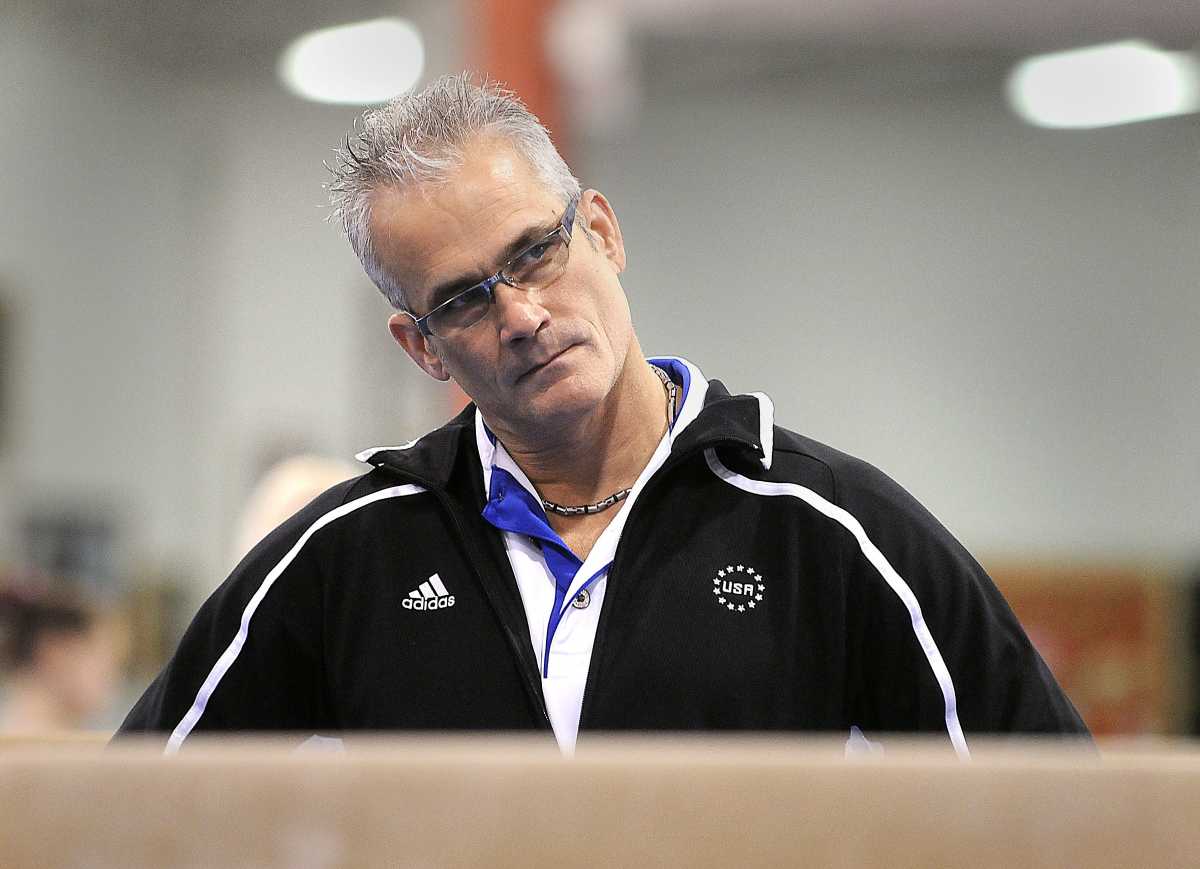 FILE PHOTO: Former U.S. Olympic gymnastics coach John Geddert has died by suicide. He is seen watching his students during practice in Lansing, Michigan, U.S. December 14, 2011. Greg DeRuiter