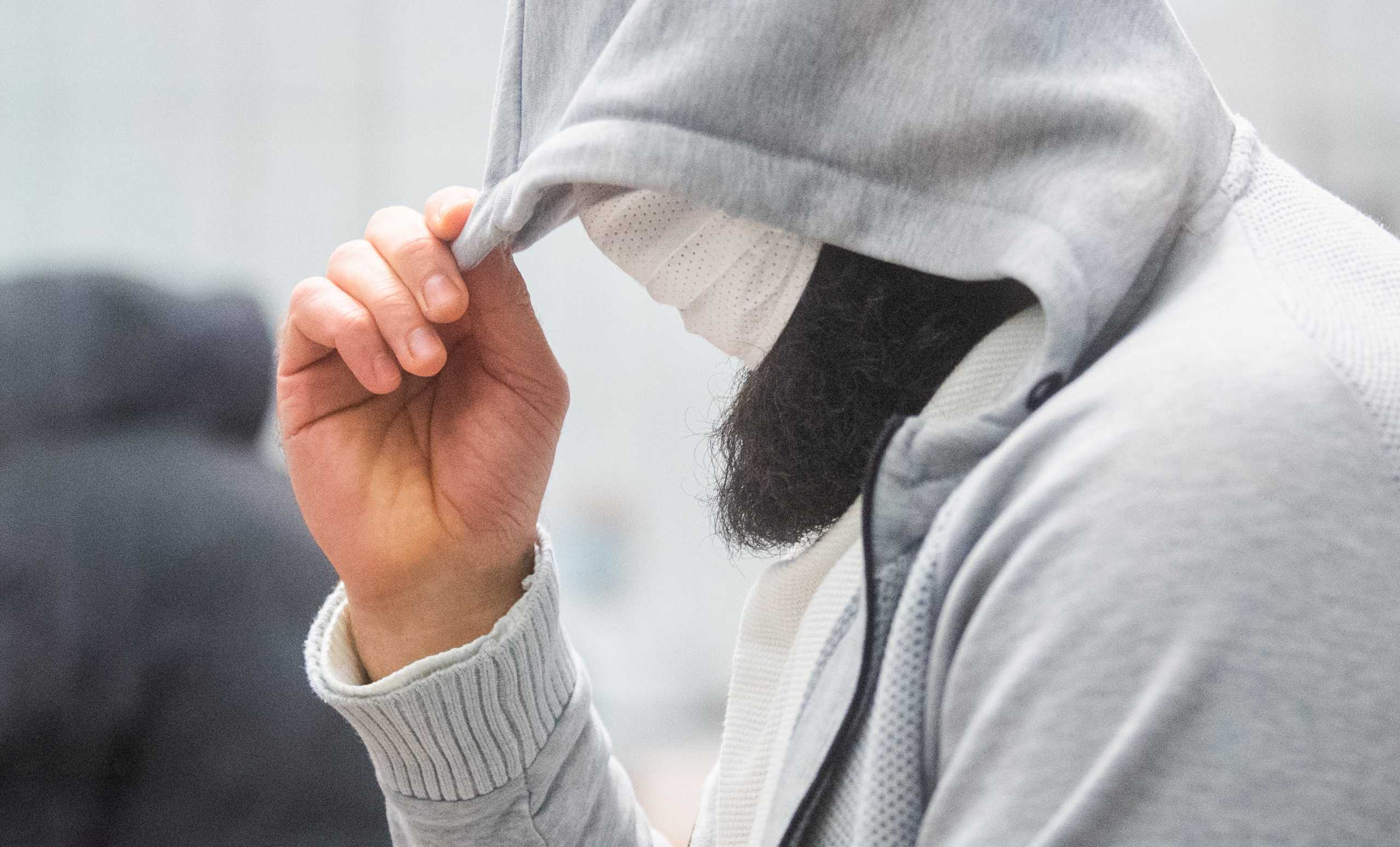 Iraqi defendant Ahmad Abdulaziz Abdullah Abdullah, known as Abu Walaa, accused of being "IS' representative in Germany" arrives in a courtroom in Celle, Germany, February 24, 2021.   Julian Stratenschulte