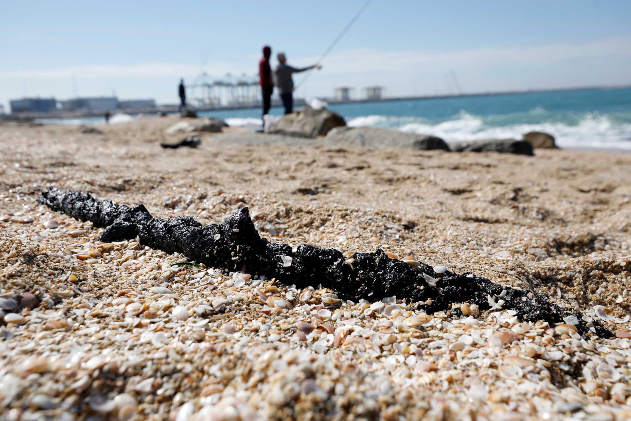 A clump of tar is seen on the sand after an offshore oil spill drenched much of Israel's Mediterranean shoreline with tar, at a beach in Ashdod, southern Israel February 21, 2021. REUTERS