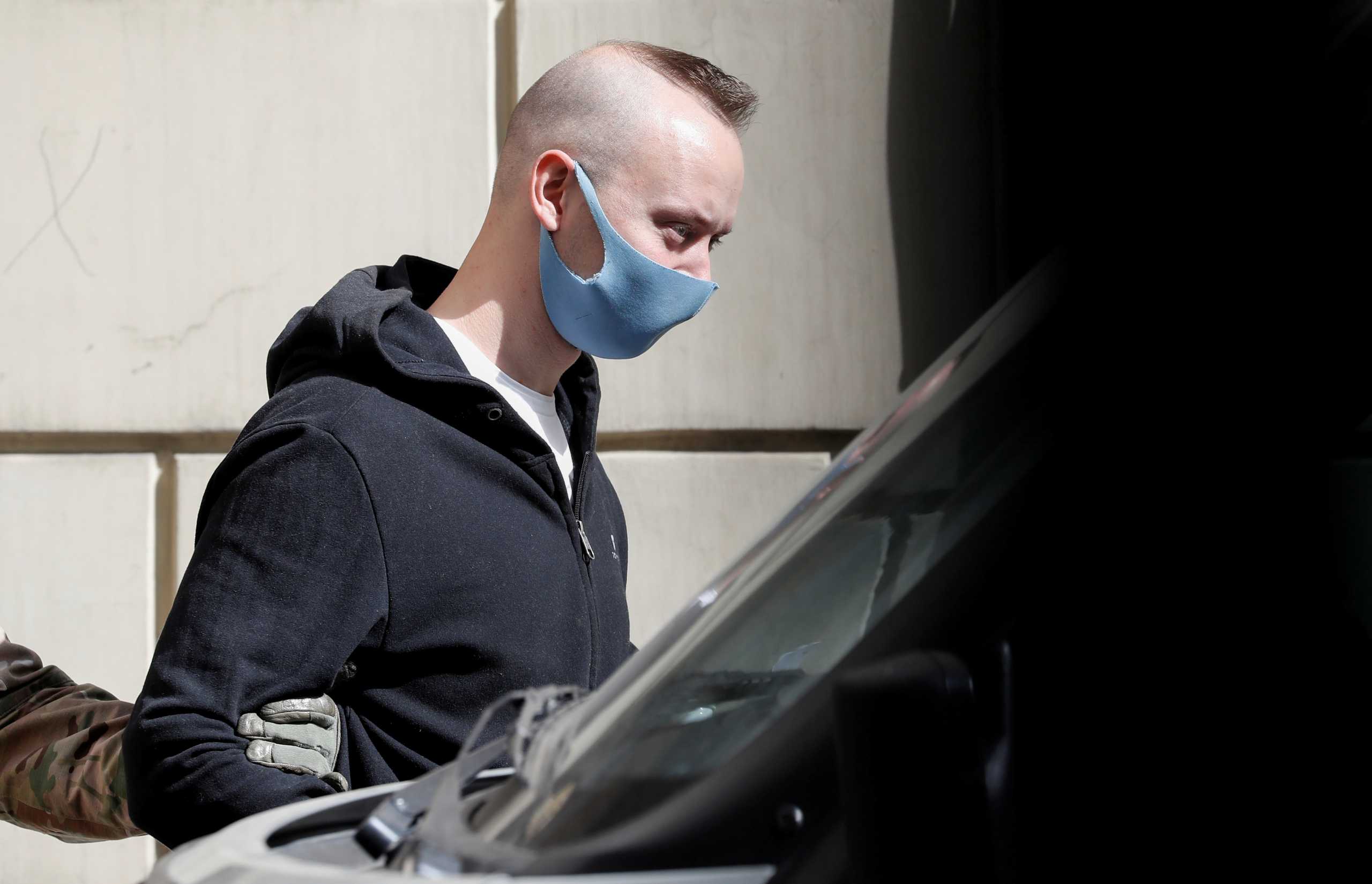 FILE PHOTO: Ivan Safronov, a former journalist and an aide to the head of Russia's space agency Roscosmos who remains in custody on state treason charges, is escorted after a court hearing in Moscow, Russia September 2, 2020. REUTERS