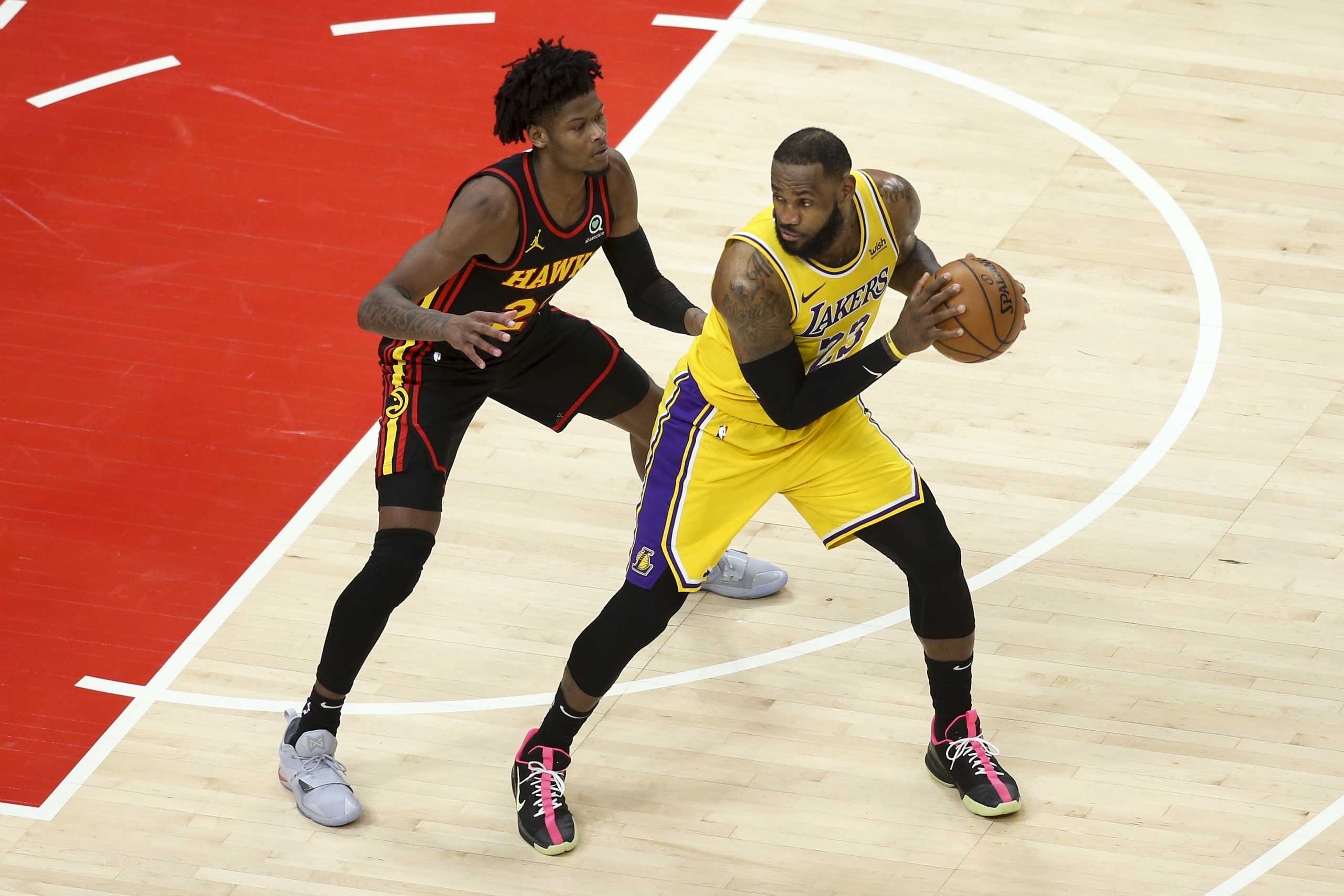 Feb 1, 2021; Atlanta, Georgia, USA; Atlanta Hawks guard Cam Reddish (22) defends Los Angeles Lakers forward LeBron James (23) in the fourth quarter at State Farm Arena. Mandatory Credit: Brett Davis-USA TODAY Sports