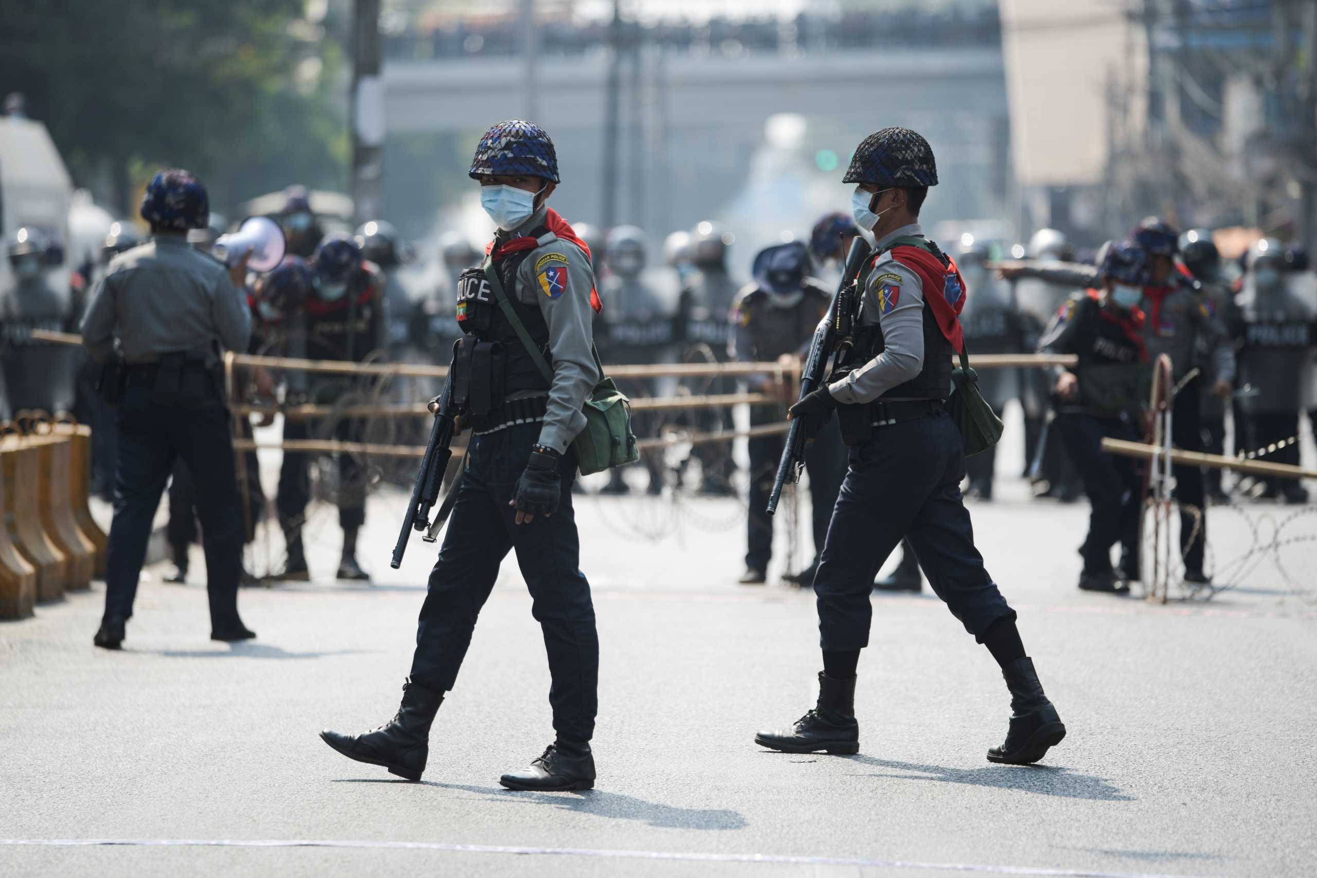 Police officers patrol as people protest against the military coup and demand the release of elected leader Aung San Suu Kyi, in Yangon, Myanmar, February 6, 2021. REUTERS