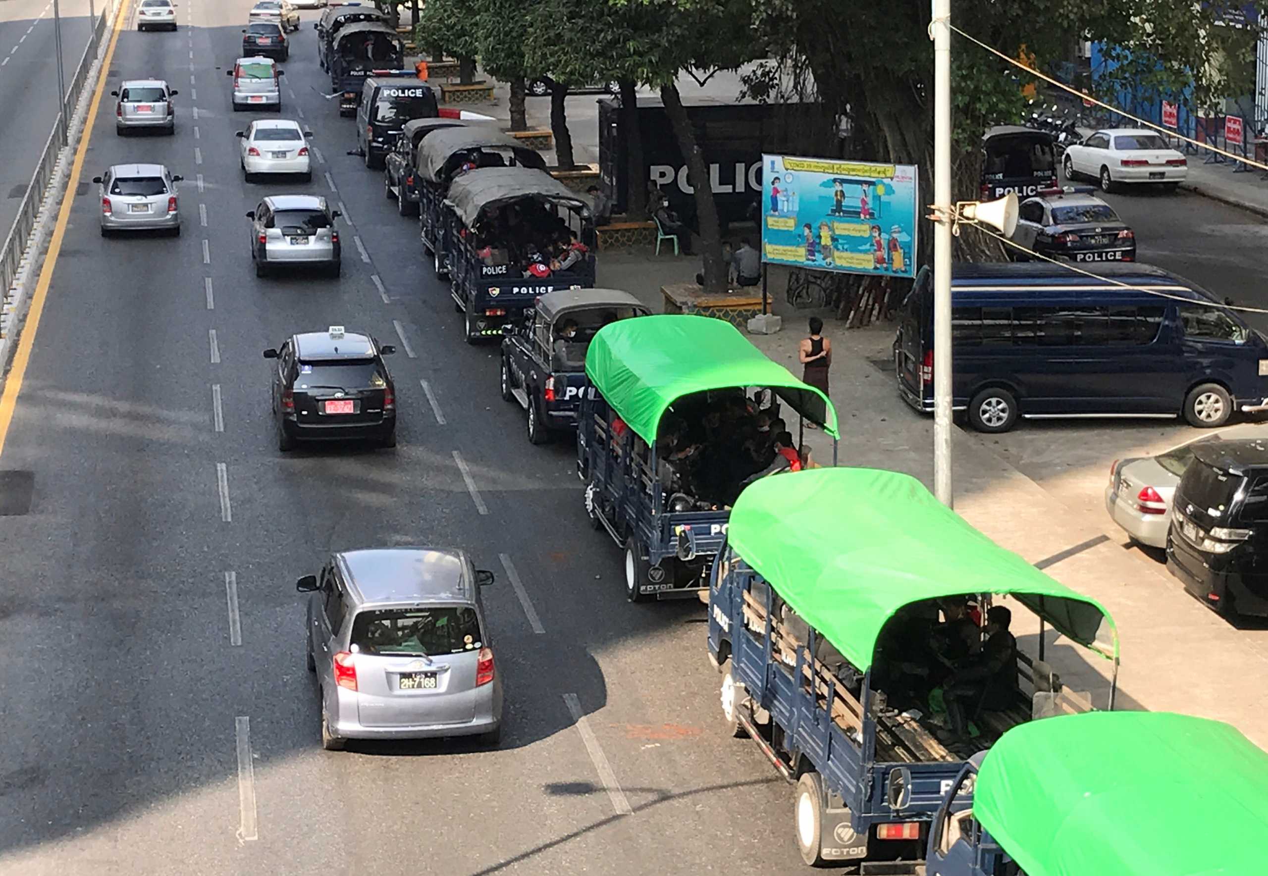 Myanmar police vehicles drive near the City Hall in Yangon, Myanmar February 1, 2021. REUTERS