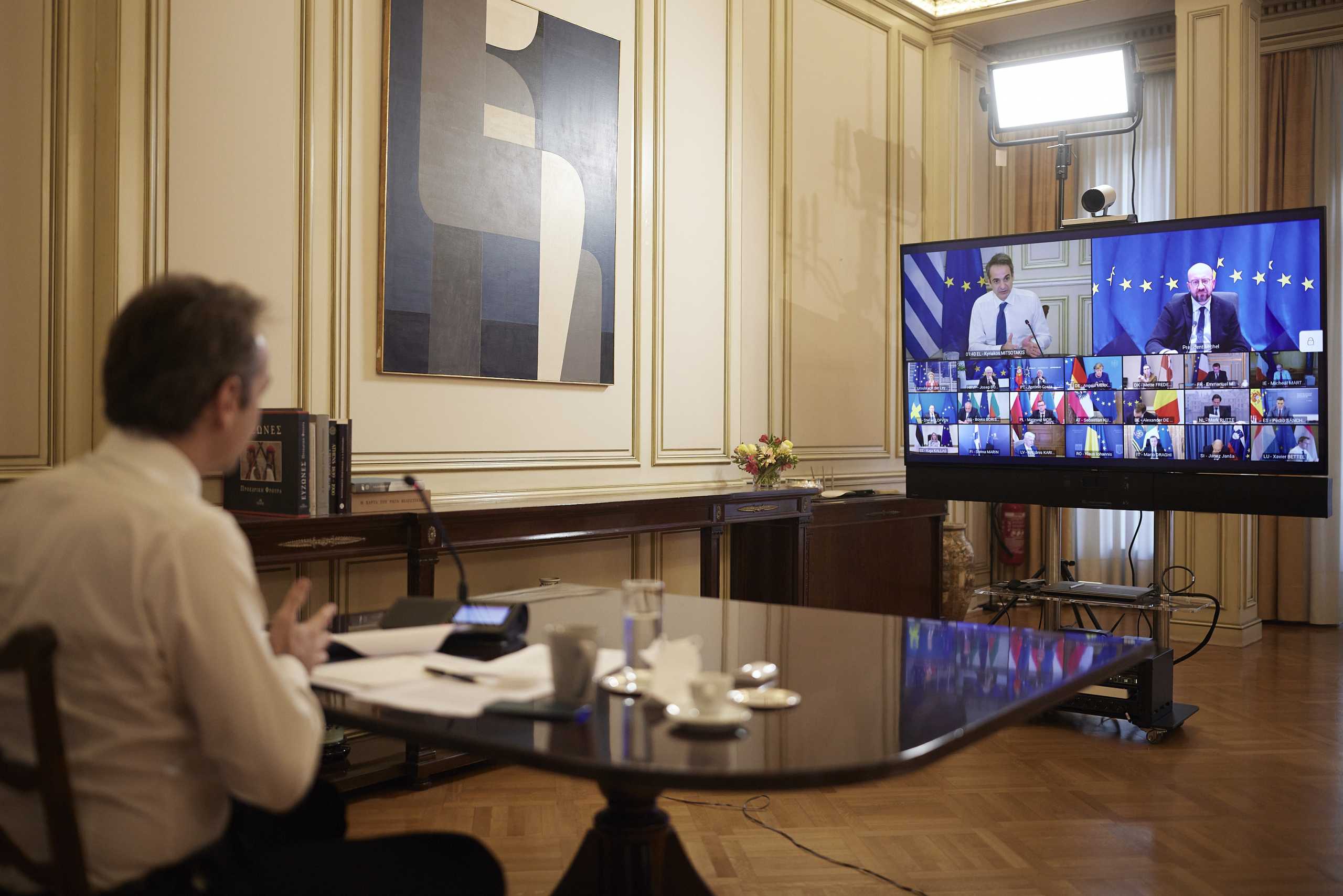 Greece's Prime Minister Kyriakos Mitsotakis speaks with EU leaders during an EU summit, via videoconference , from his office in Athens, Thursday, Feb. 25, 2021 (Dimitris Papamitsos